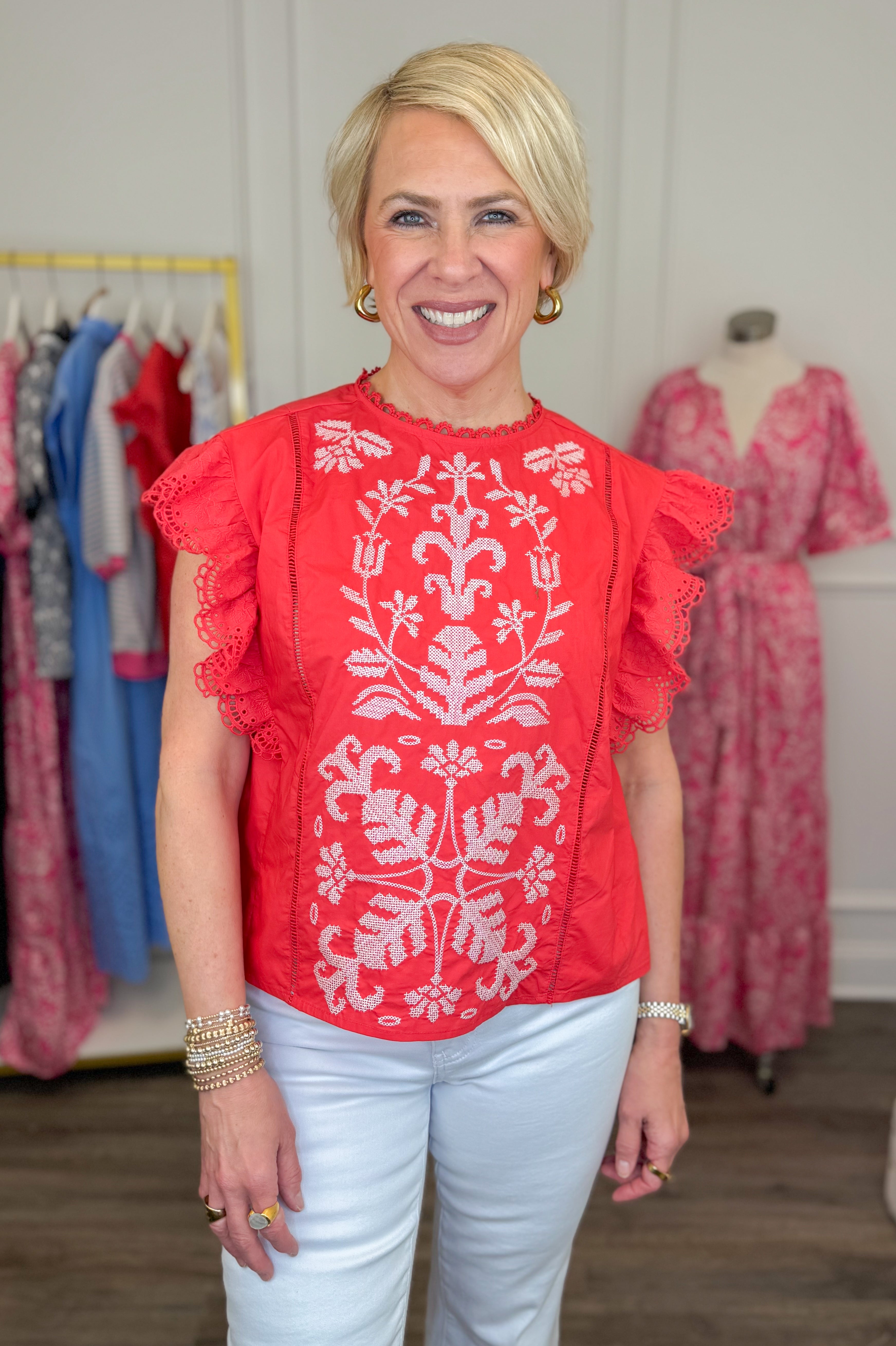 Front view of wearing Tomato Embroidered Flutter Sleeve Top by Fate with white jeans and sandals.