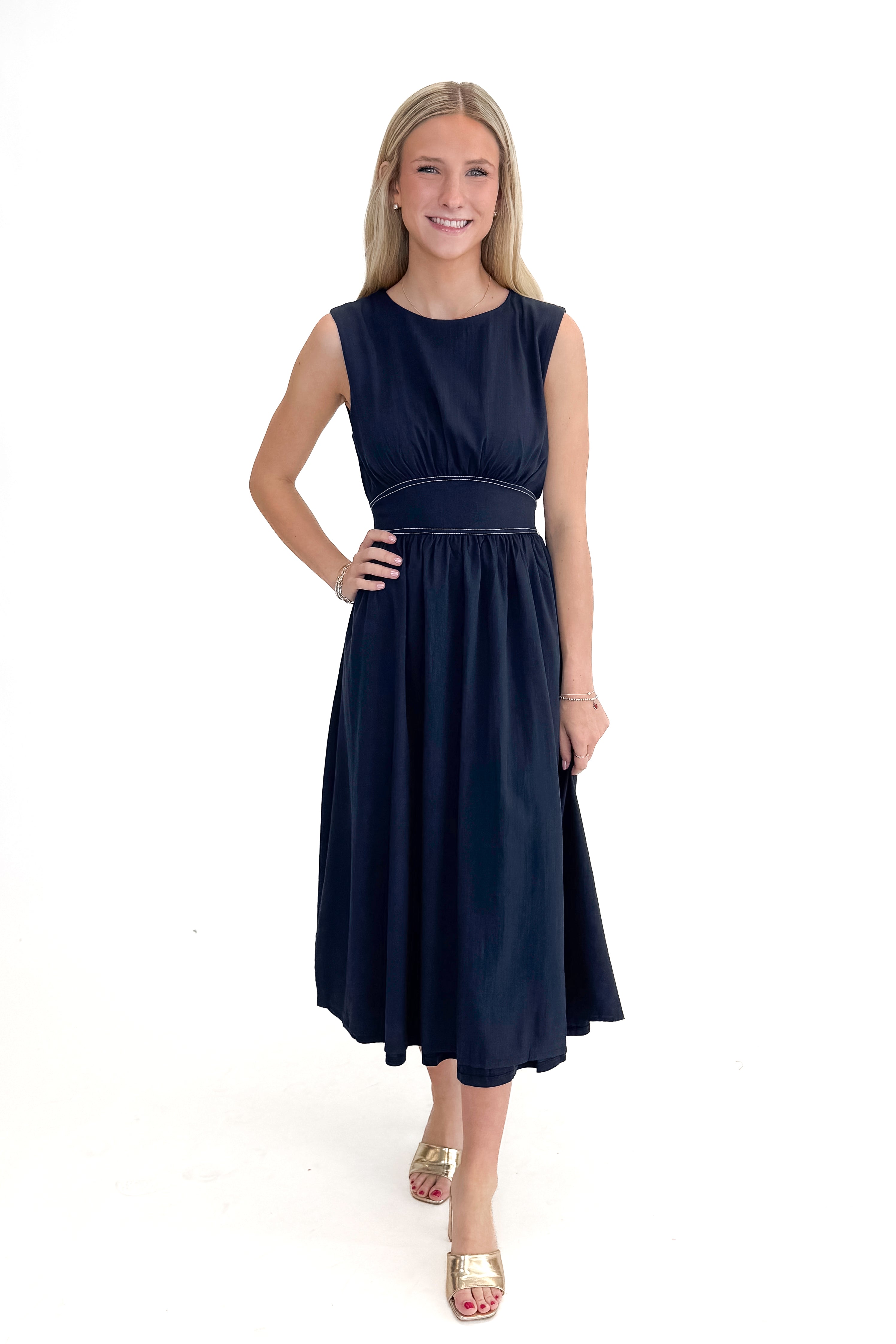 Front view of woman wearing Navy Stitch Waist Mid Dress against white studio background.