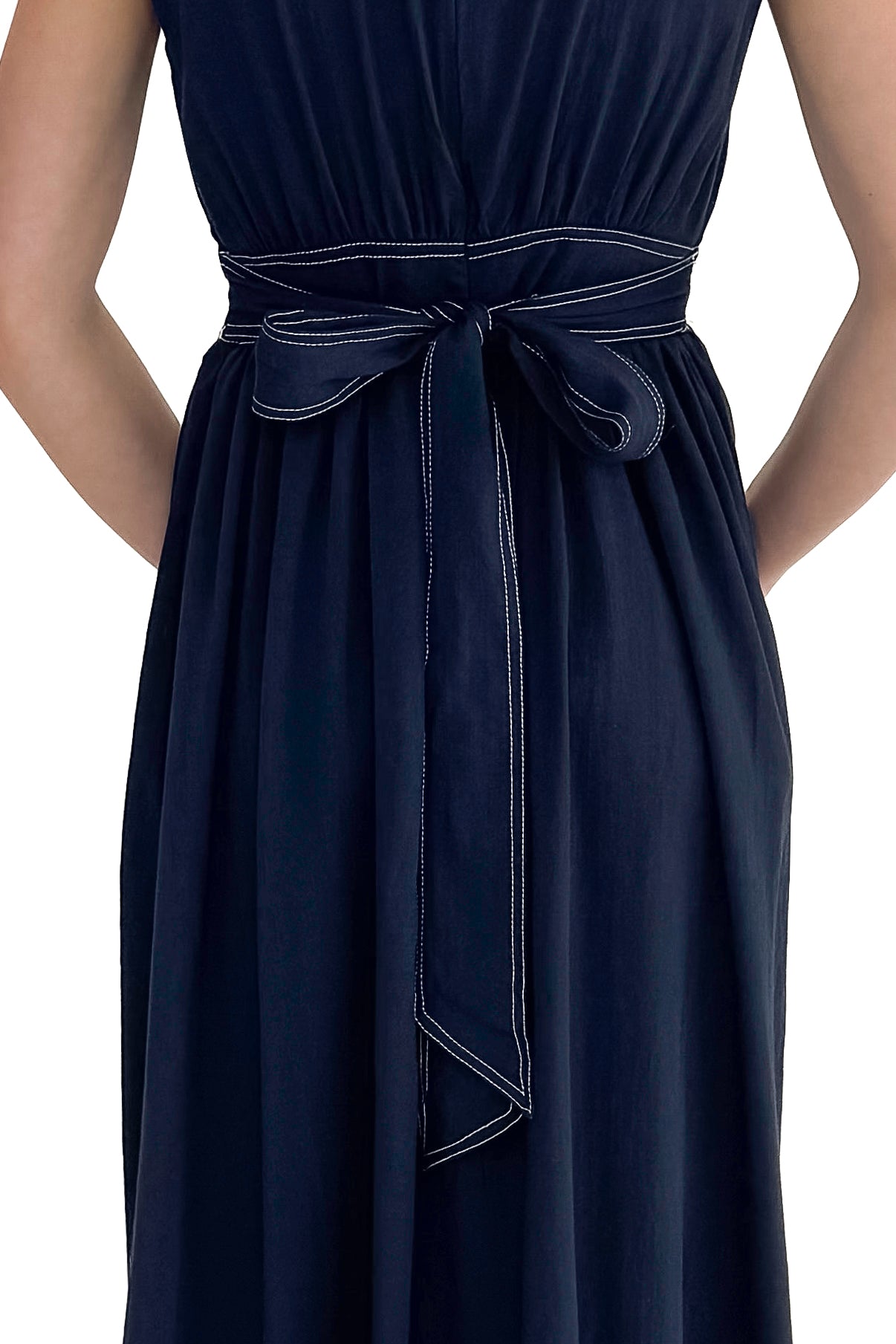 Back view of woman wearing Navy Stitch Waist Mid Dress against white studio background.