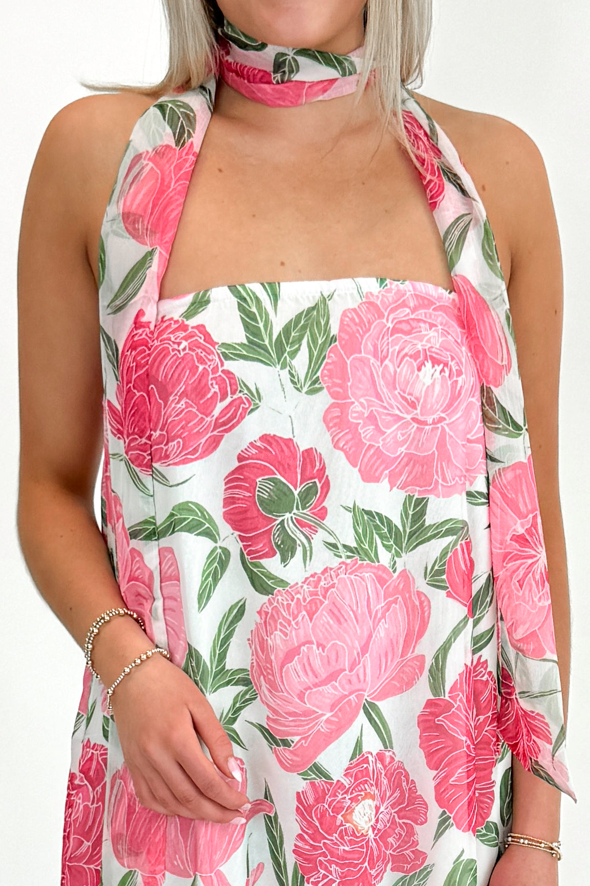 Front detail view of woman wearing Pink Floral Maxi Dress With Convertible Scarf against white studio background.