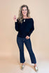 Front view picture of woman wearing Black Wide Neck Long Sleeve Top and jeans against a tan background.