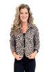 Closer up photo of woman wearing leopard print quilted jacket with pointed collar and front tie closures