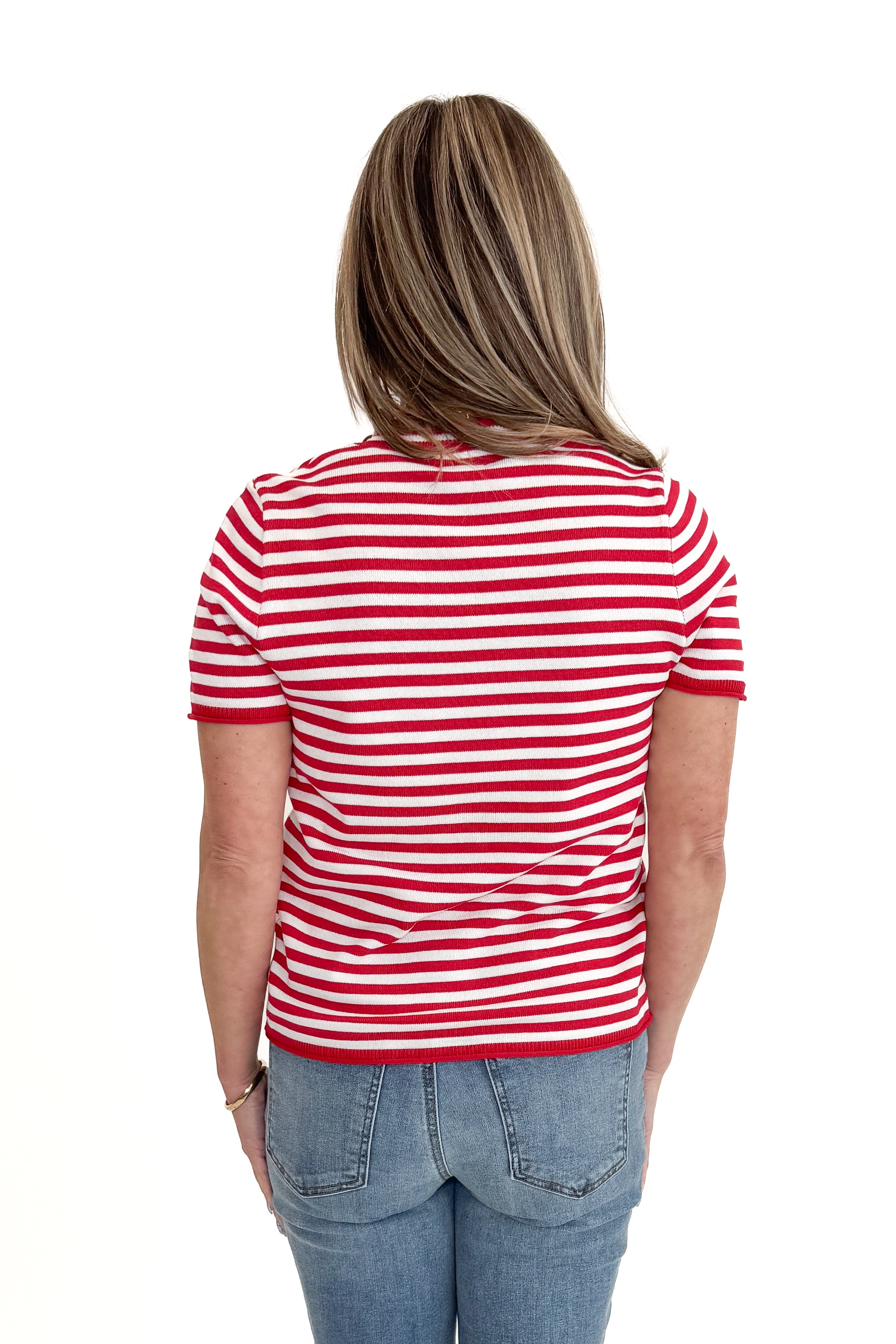 Back view of woman wearing Red & White Striped Short Sleeve Sweater with jeans against white studio background.