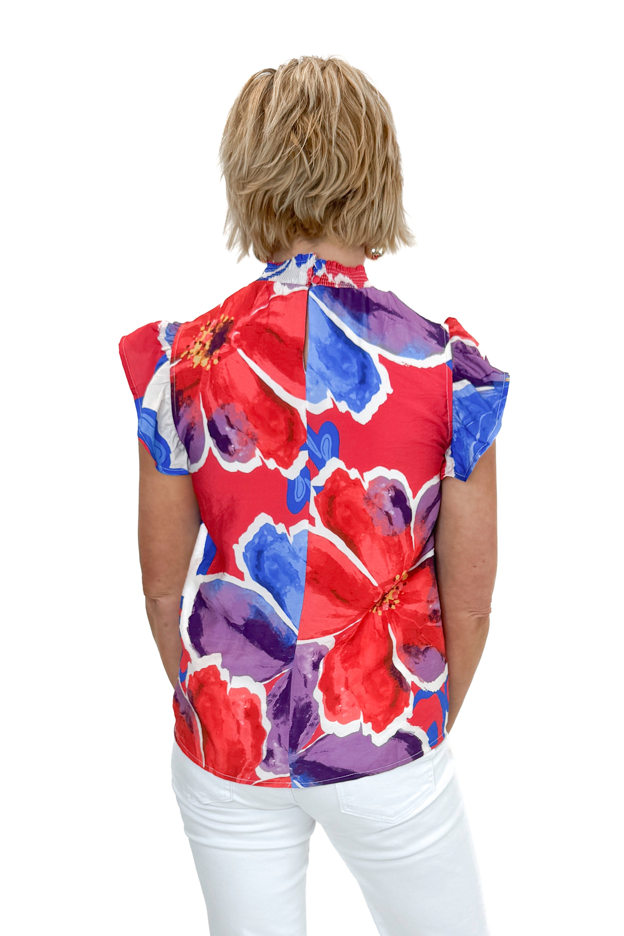 Back view of woman wearing Multi Floral Smocked Detail Top with jeans against white studio background.