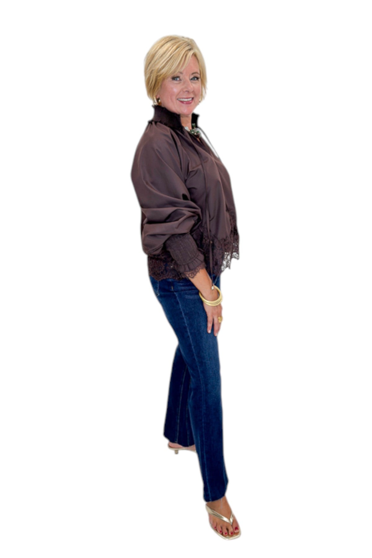 Side view of woman wearing Swagger Boutique’s Chocolate Lace Lined Top by Entro with jeans against white studio background.