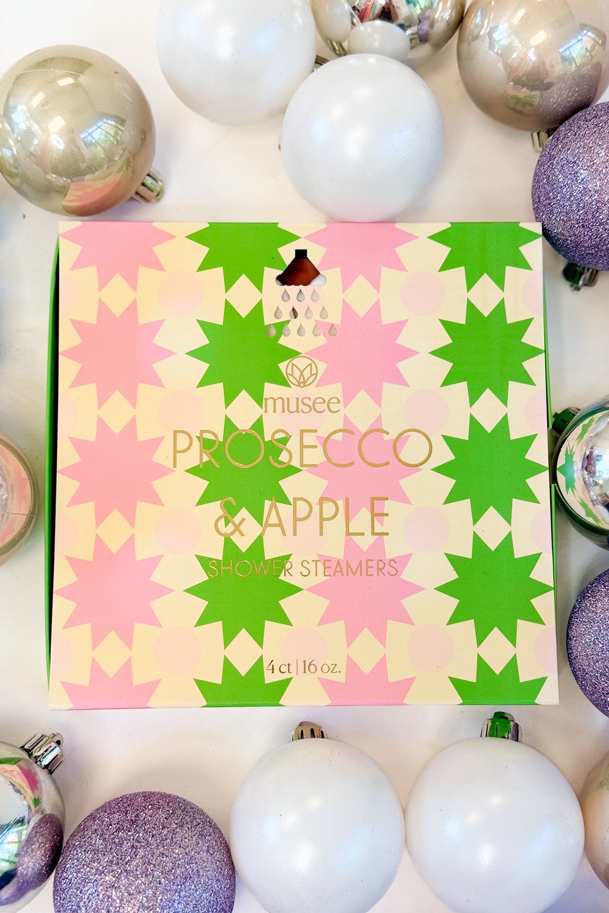 Christmas Shower Steamers against holiday background Prosecco & Apple