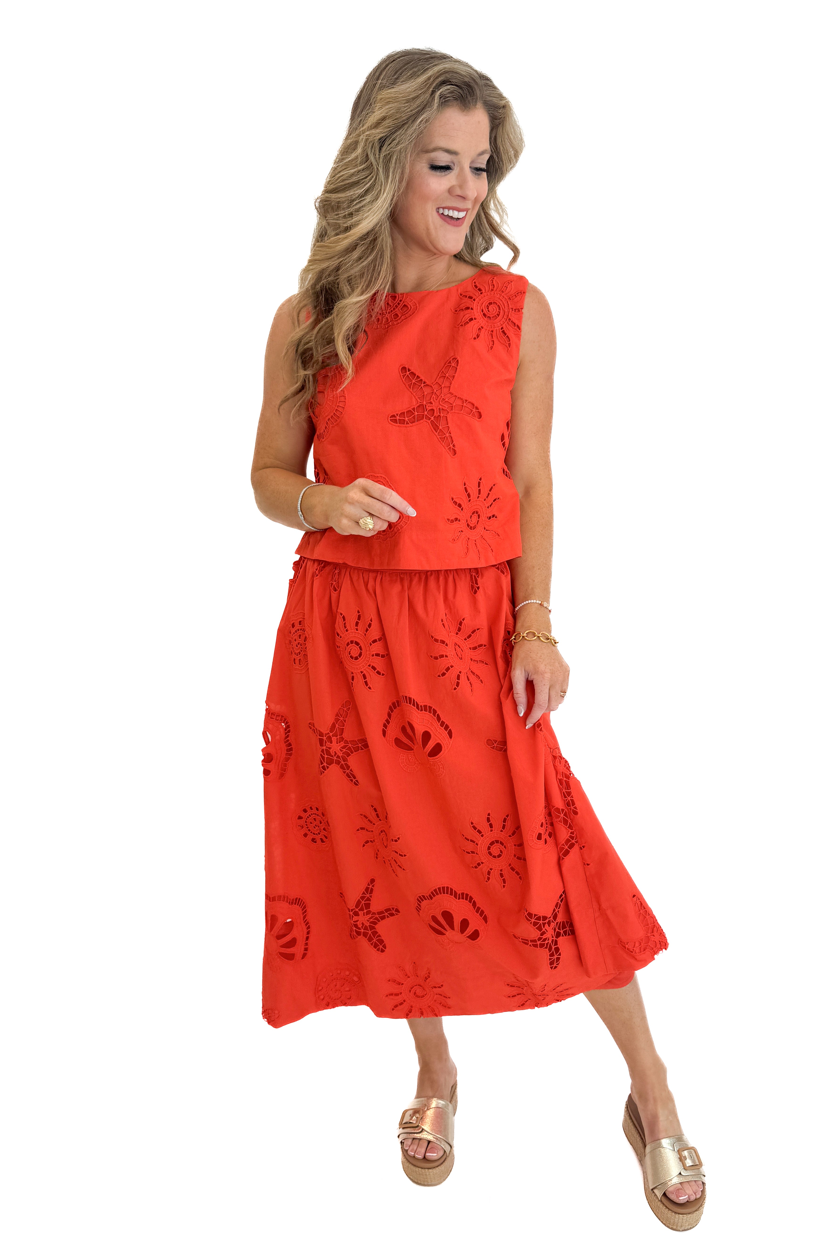 Front view of woman wearing Swagger Boutiqueβs Coral Shell Embroidered Tank with matching Coral Shell Embroidered Midi Skirt against white studio background.