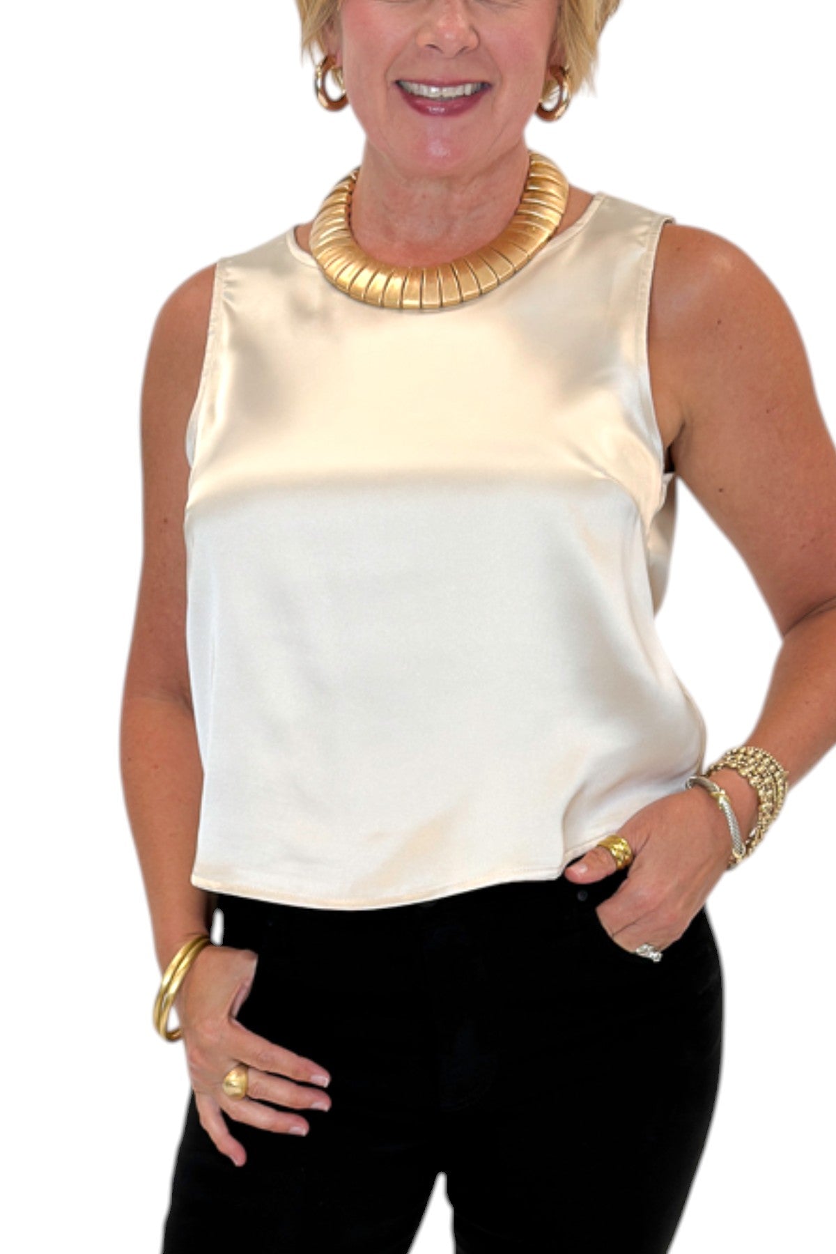 Front detail view of woman wearing Swagger Boutiqueās cream satin tank with jeans against white studio background.