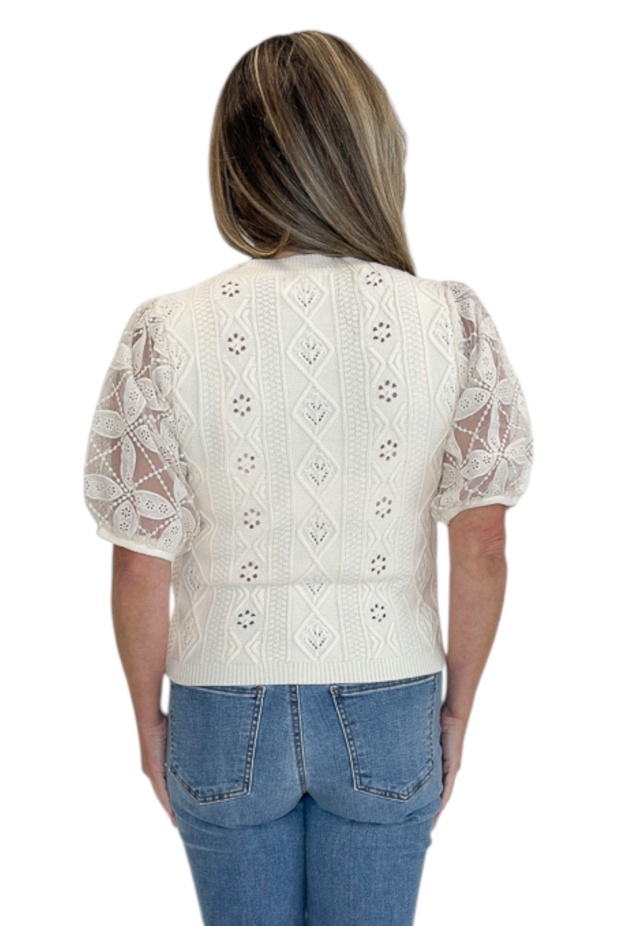 Back view of woman wearing Swagger Boutiqueās Cream Sheer Sleeve Sweater with jeans against white studio background.