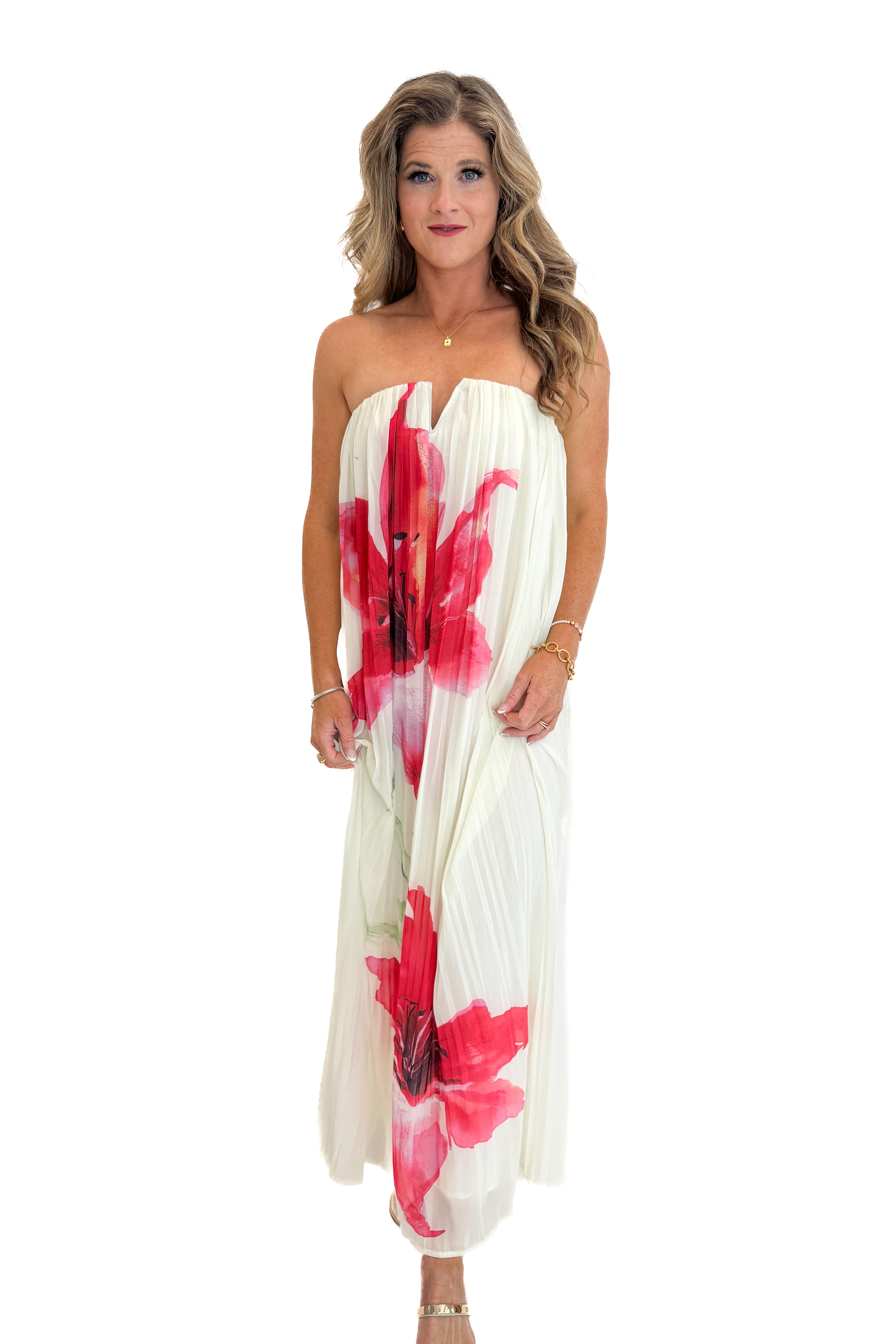 Front view of woman wearing Swagger Boutiqueβs Cream With Large Floral Print Pleat Detail Maxi Dress with sandals against white studio background.