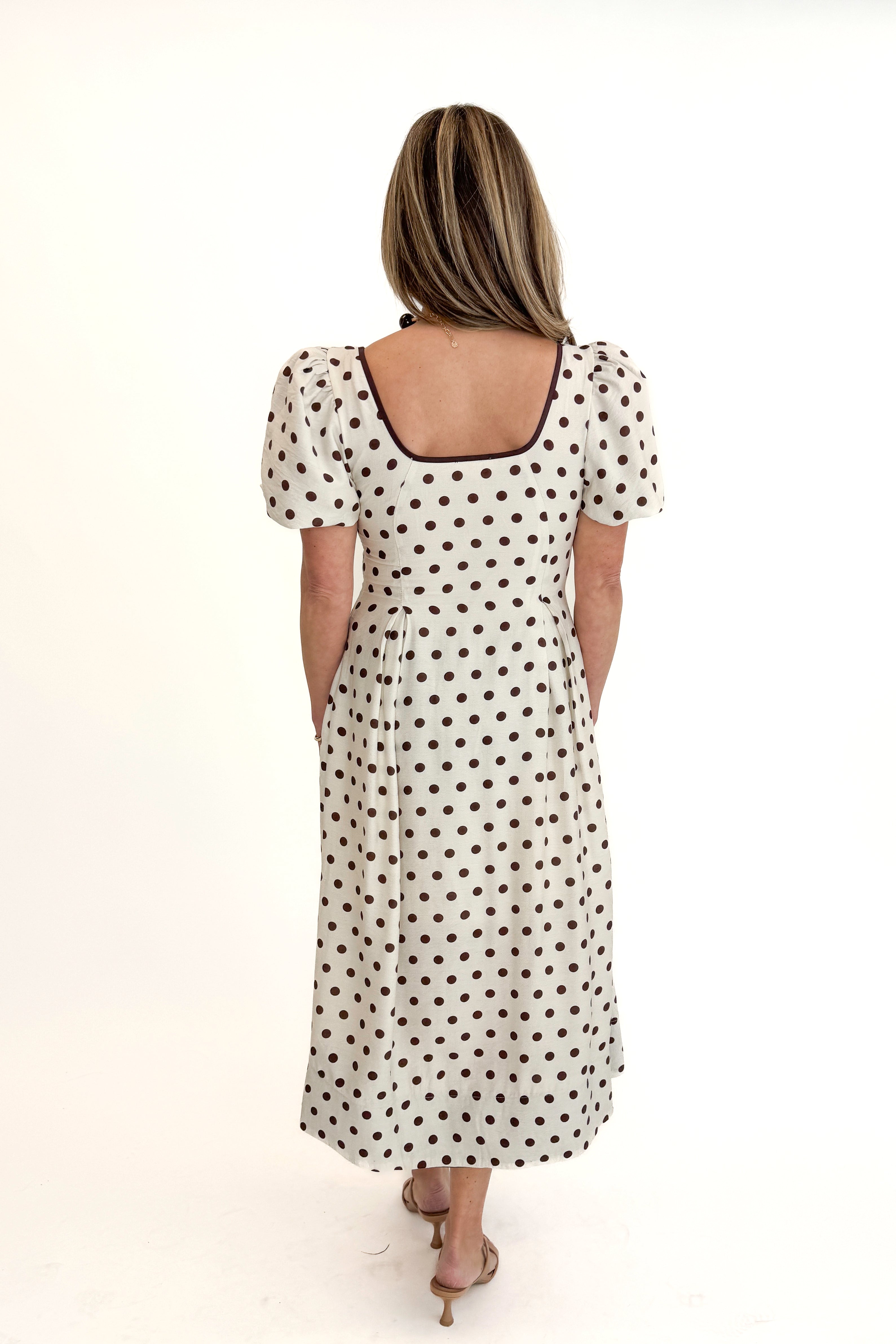 Back view of woman wearing Cream With Brown Stripe Detail Polka Dot Midi Dress by Entro against white studio background.
