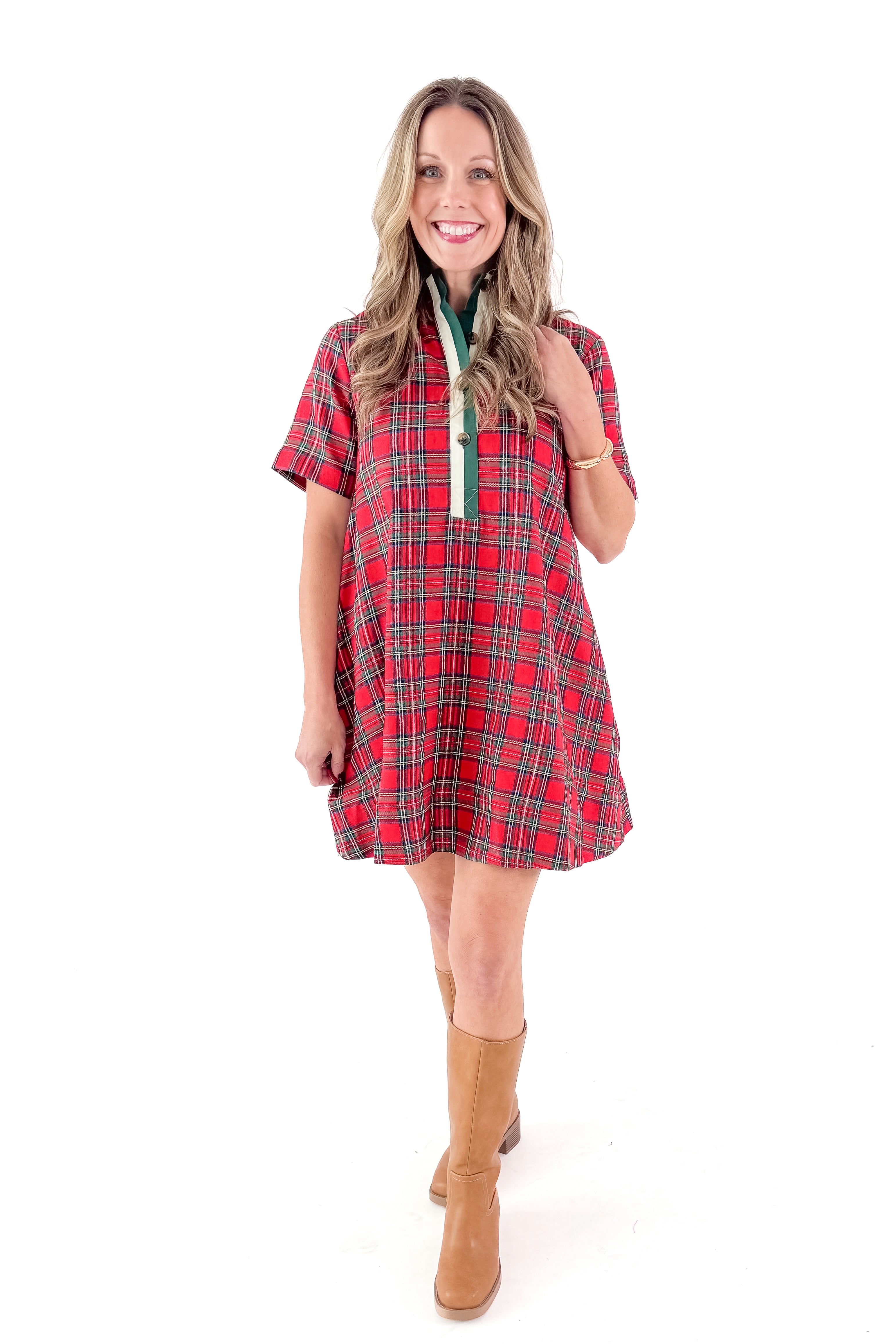 Front view of woman wearing Red Gingham Dress by Entro with boots against white studio background.