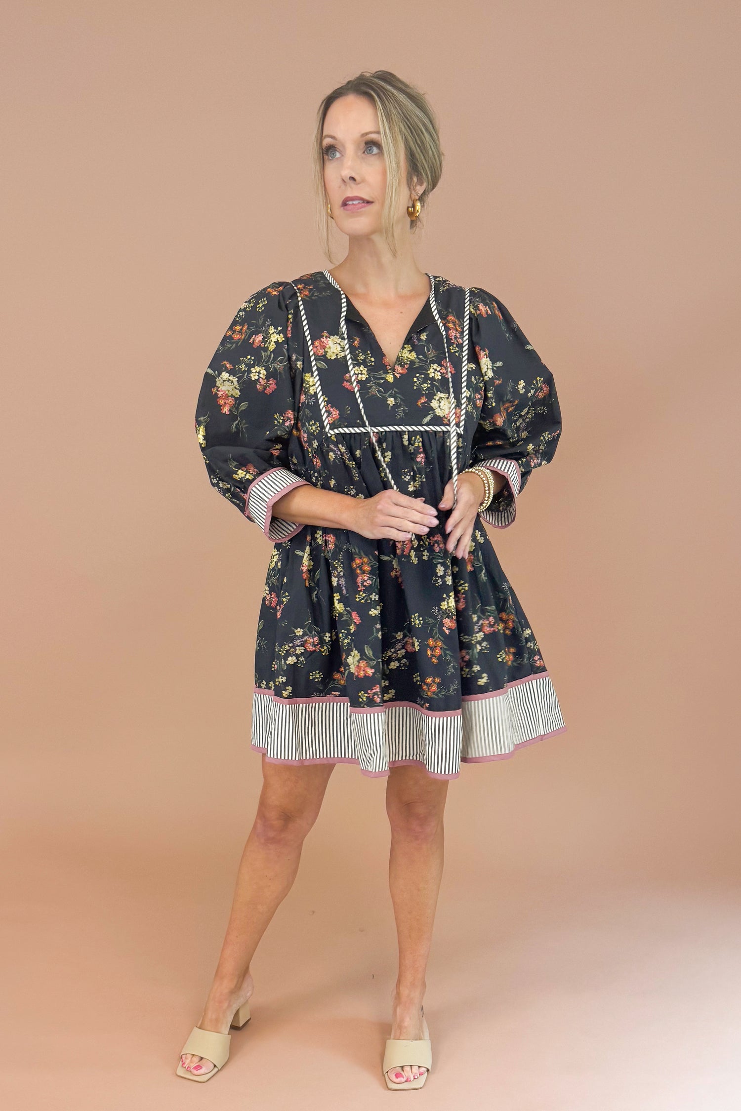 Woman wearing a floral dress with a plain background