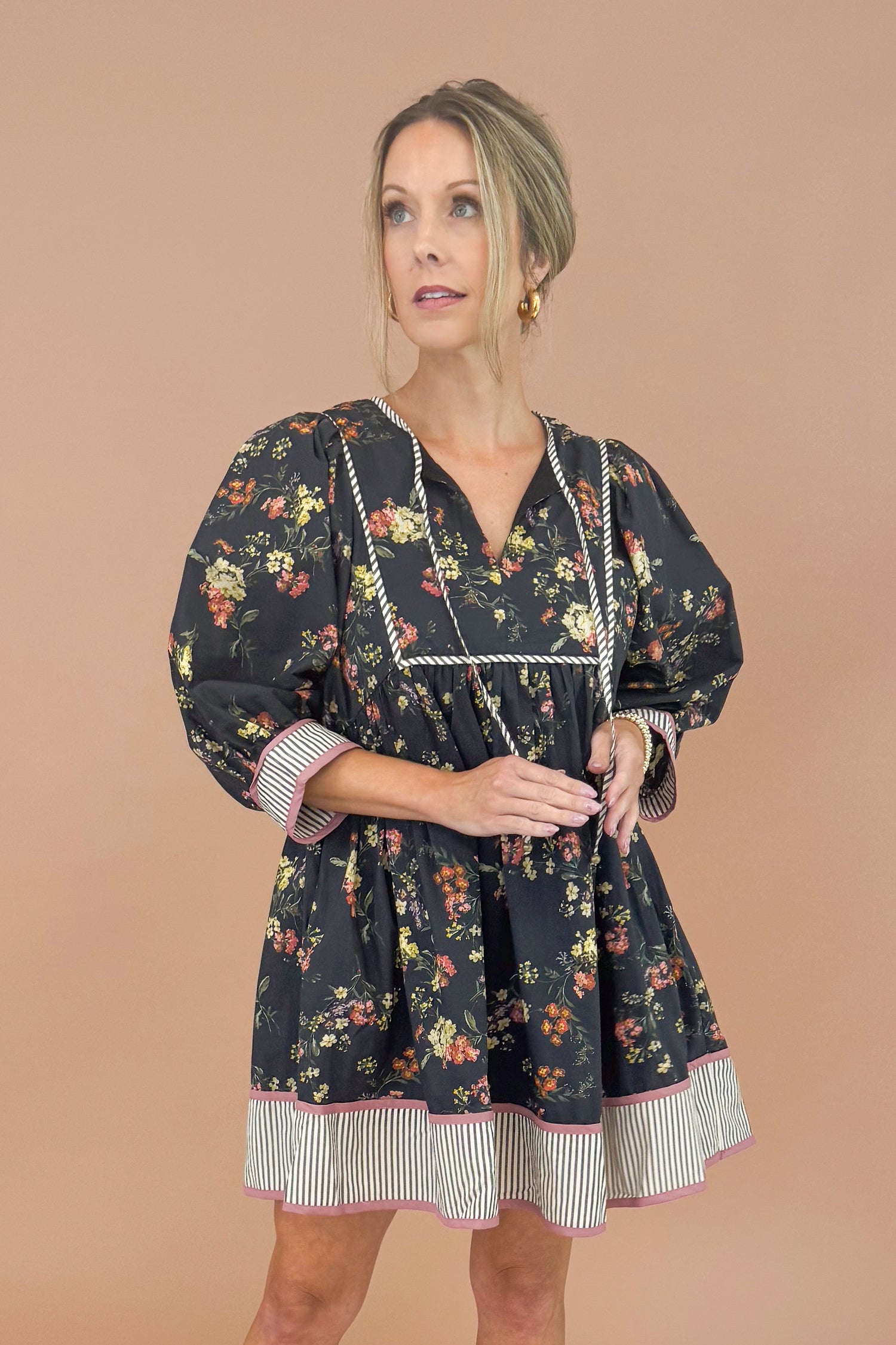 Woman wearing a floral dress with a plain background