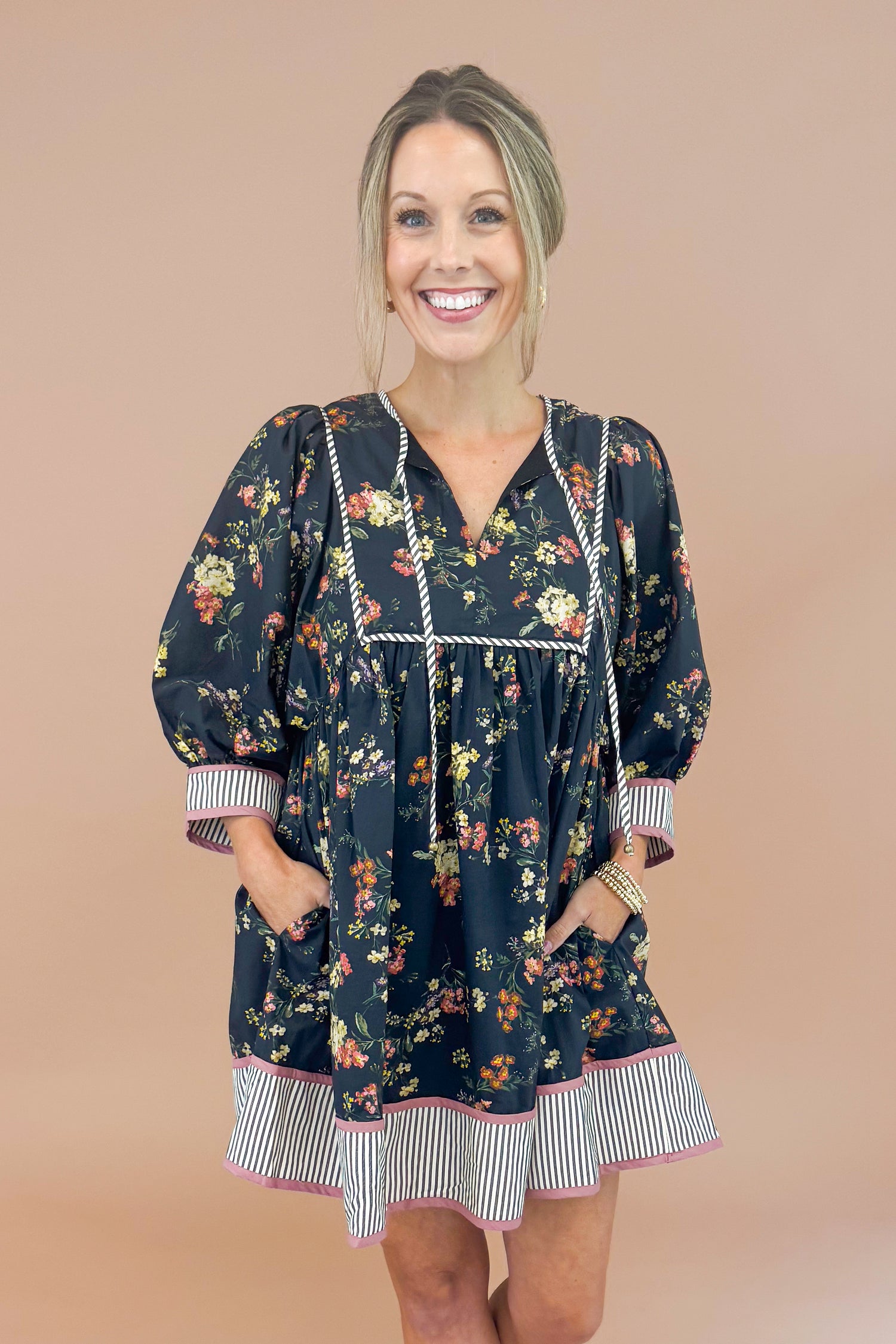 Woman wearing a floral dress with a plain background