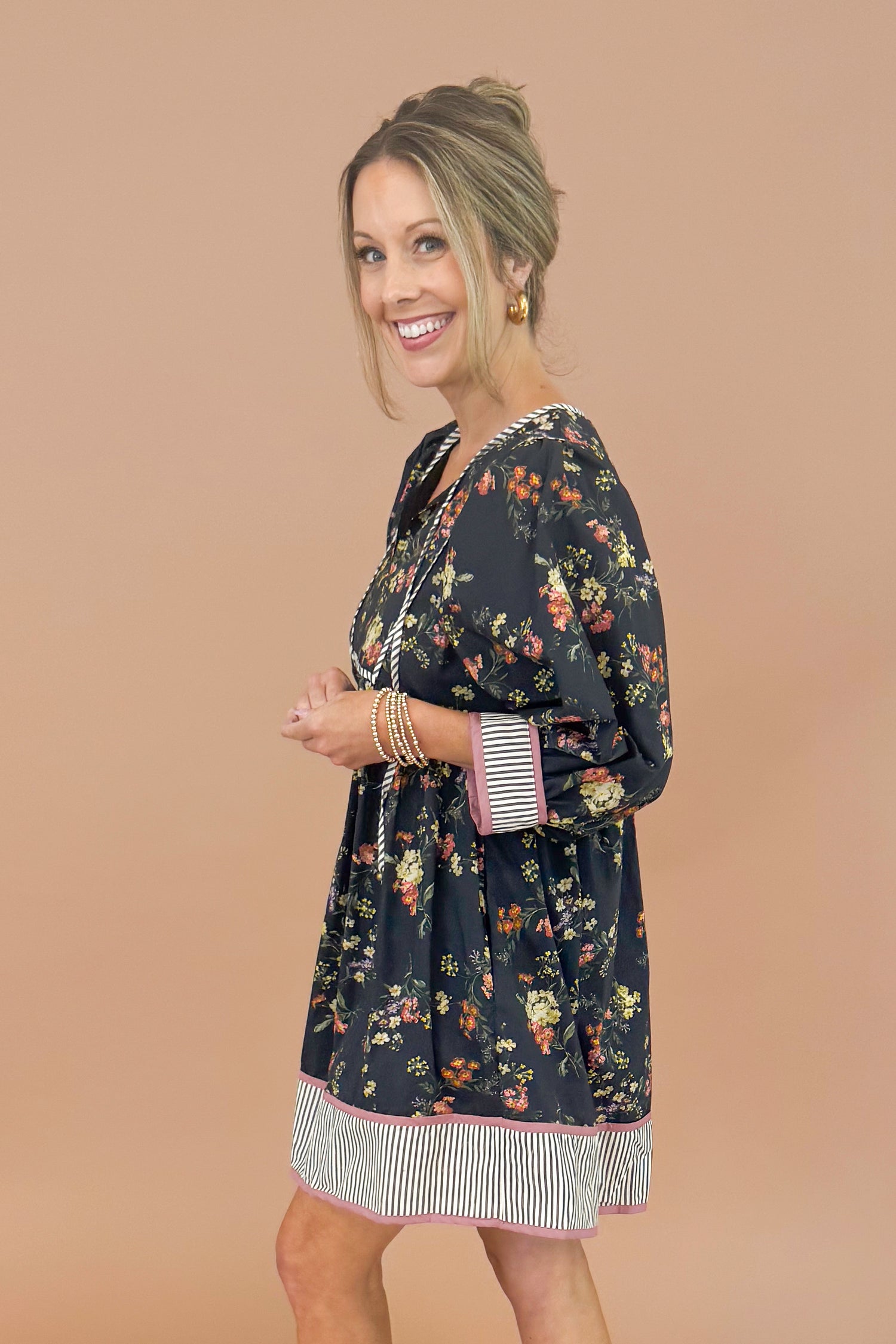 Woman wearing a floral dress with a plain background