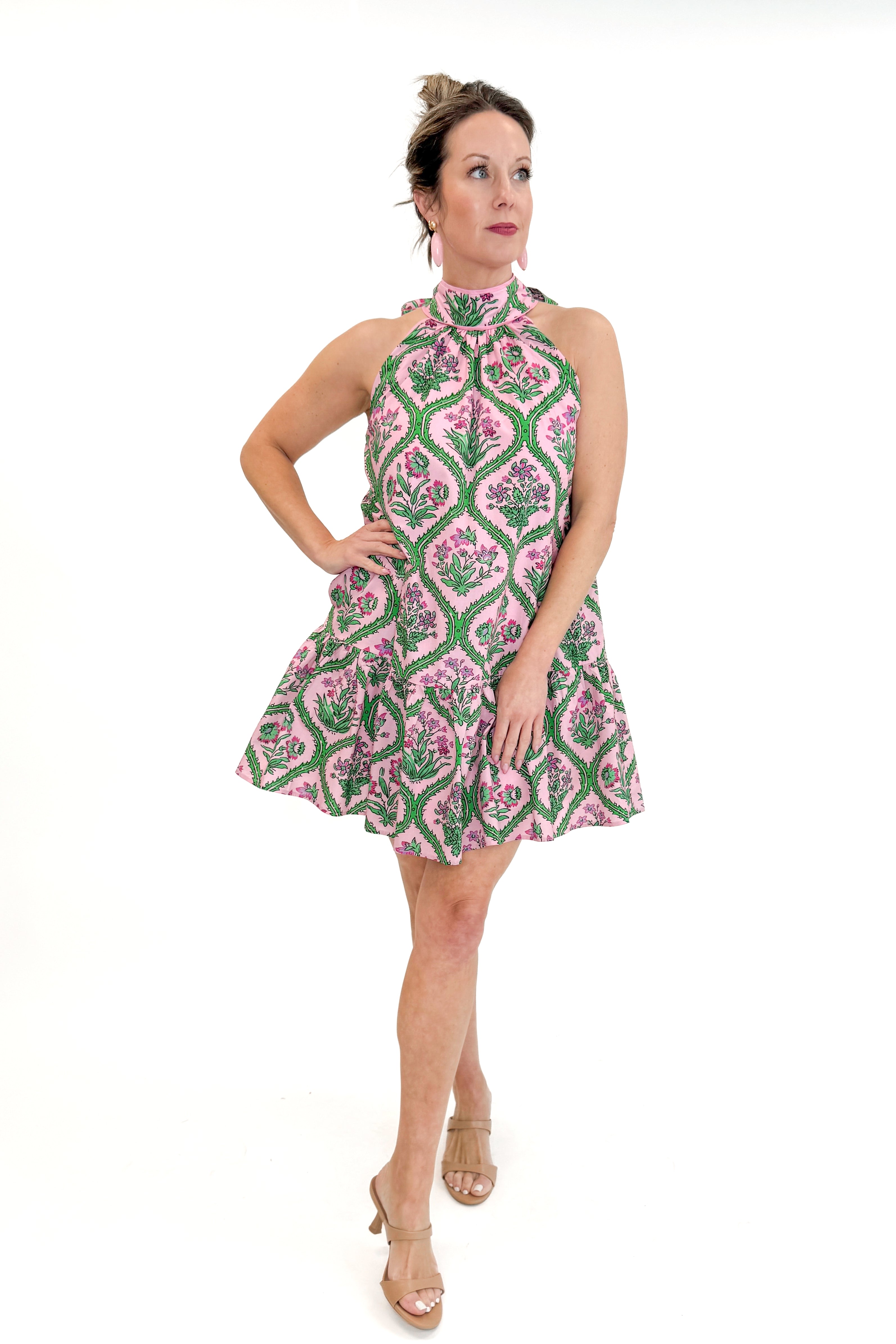 Front view of woman wearing Pink & Green Floral Halter Neck Dress by Entro against white studio background.