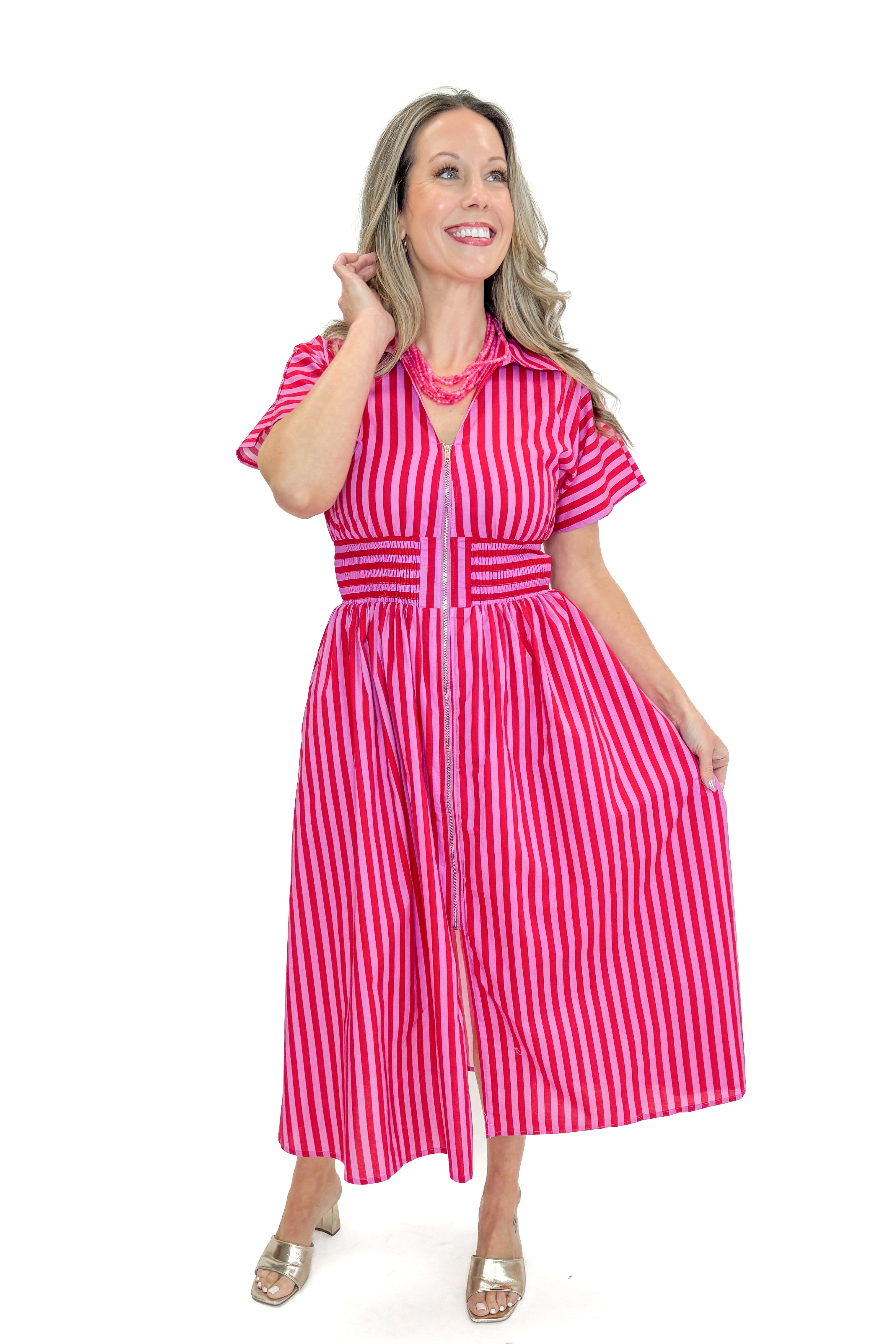 Front view of woman wearing Red & Pink Striped Center Zip Midi Dress by Entro against white studio background.
