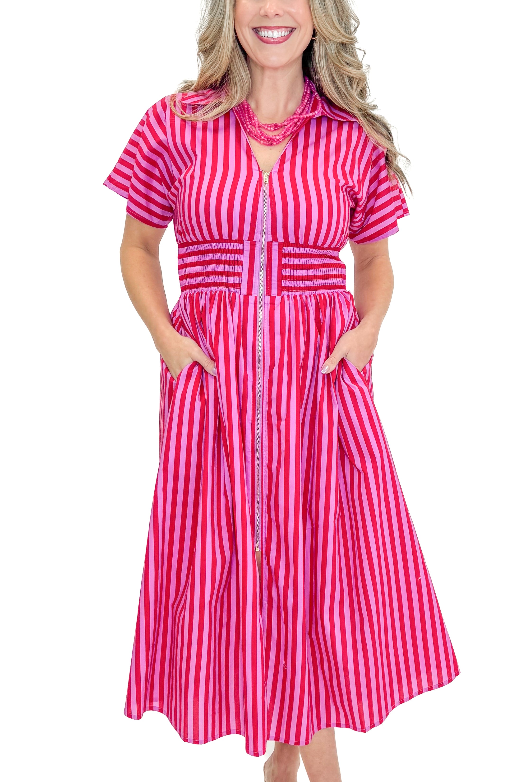Front view of woman wearing Red & Pink Striped Center Zip Midi Dress by Entro against white studio background.