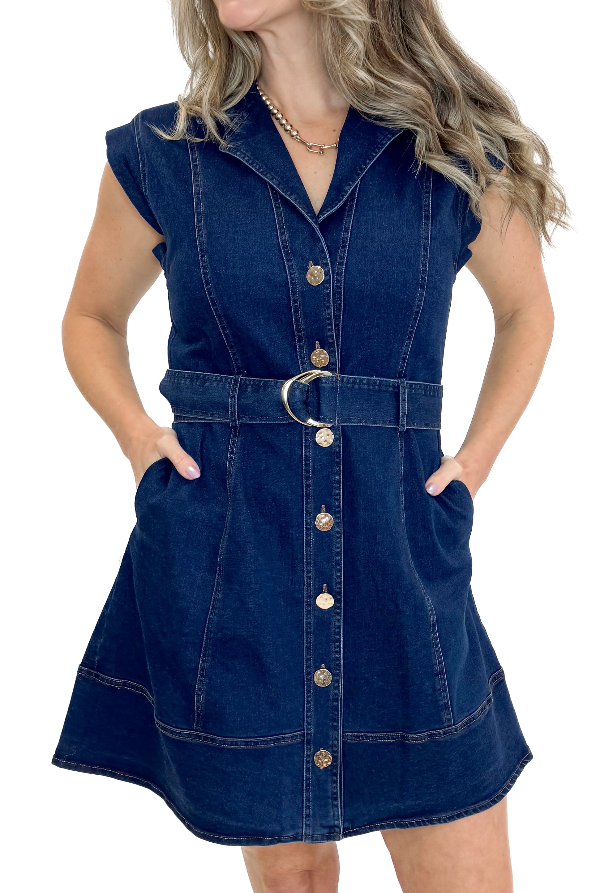 Front detail view of woman wearing Denim Button Up Mini Dress by Entro against white studio background.