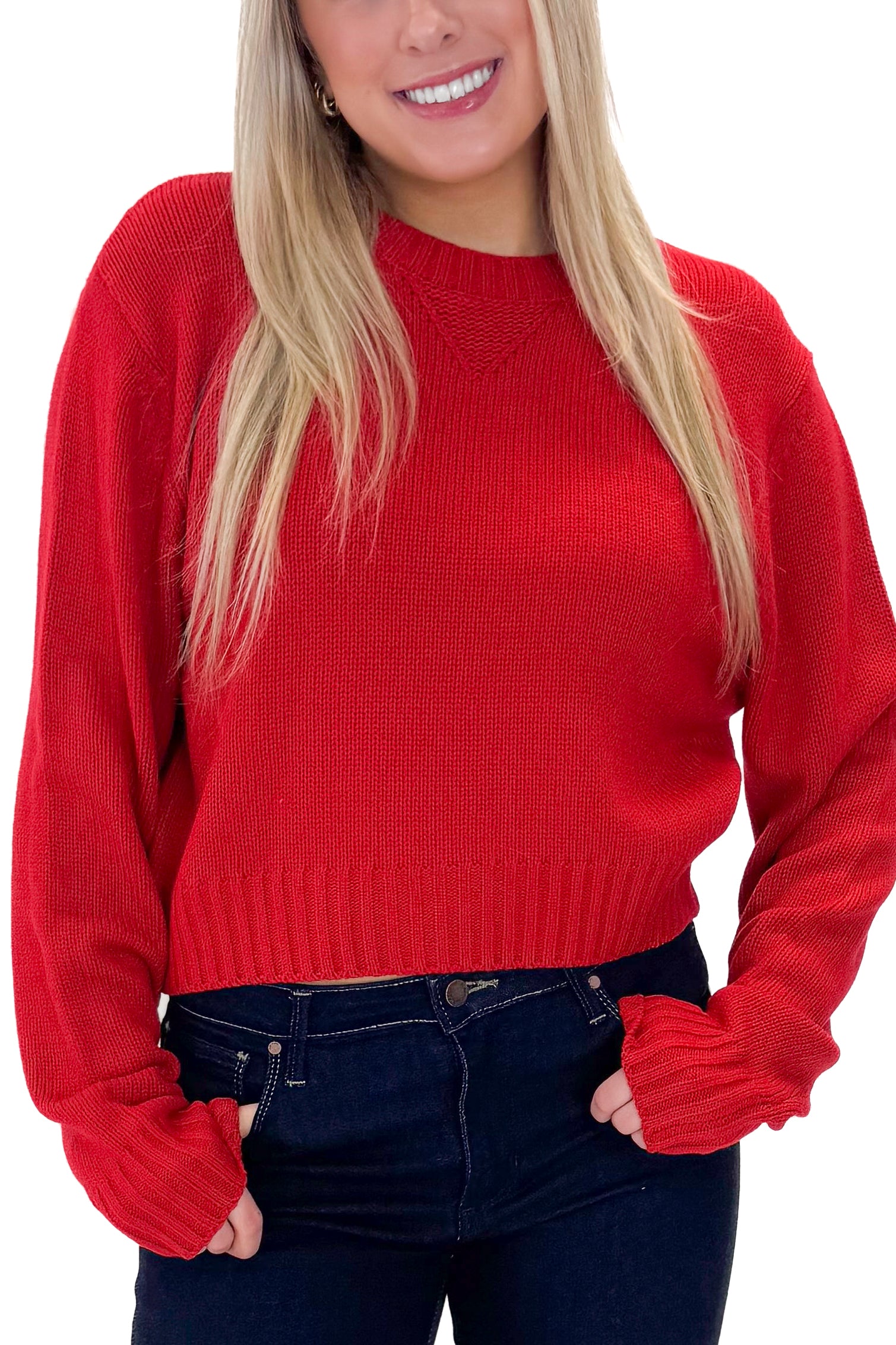 Front detail view of woman wearing Red Ribbed Neck Sweater with jeans against white studio background.