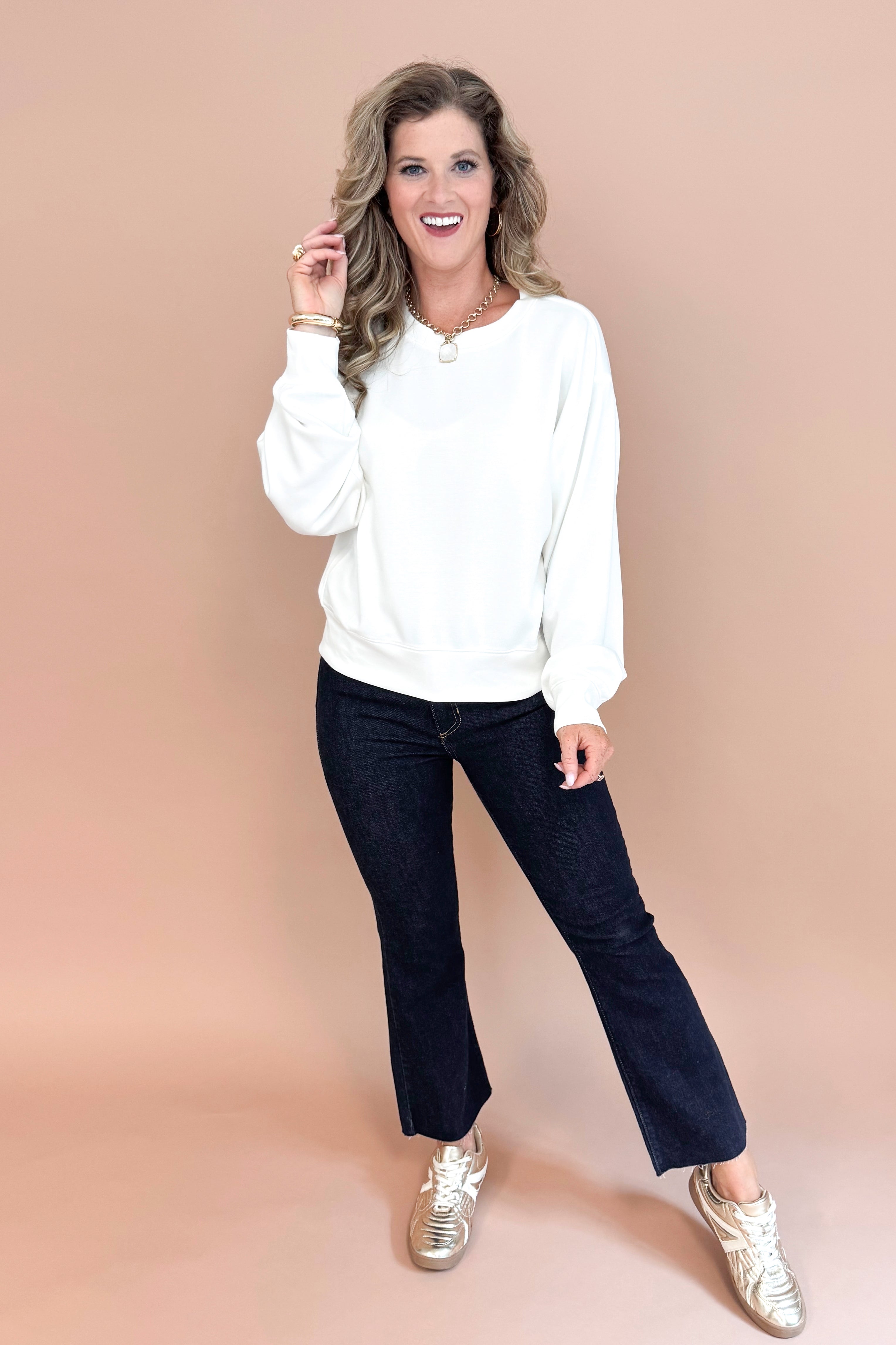 Women wearing White Crew Neck Sweatshirt and blue jeans front view.