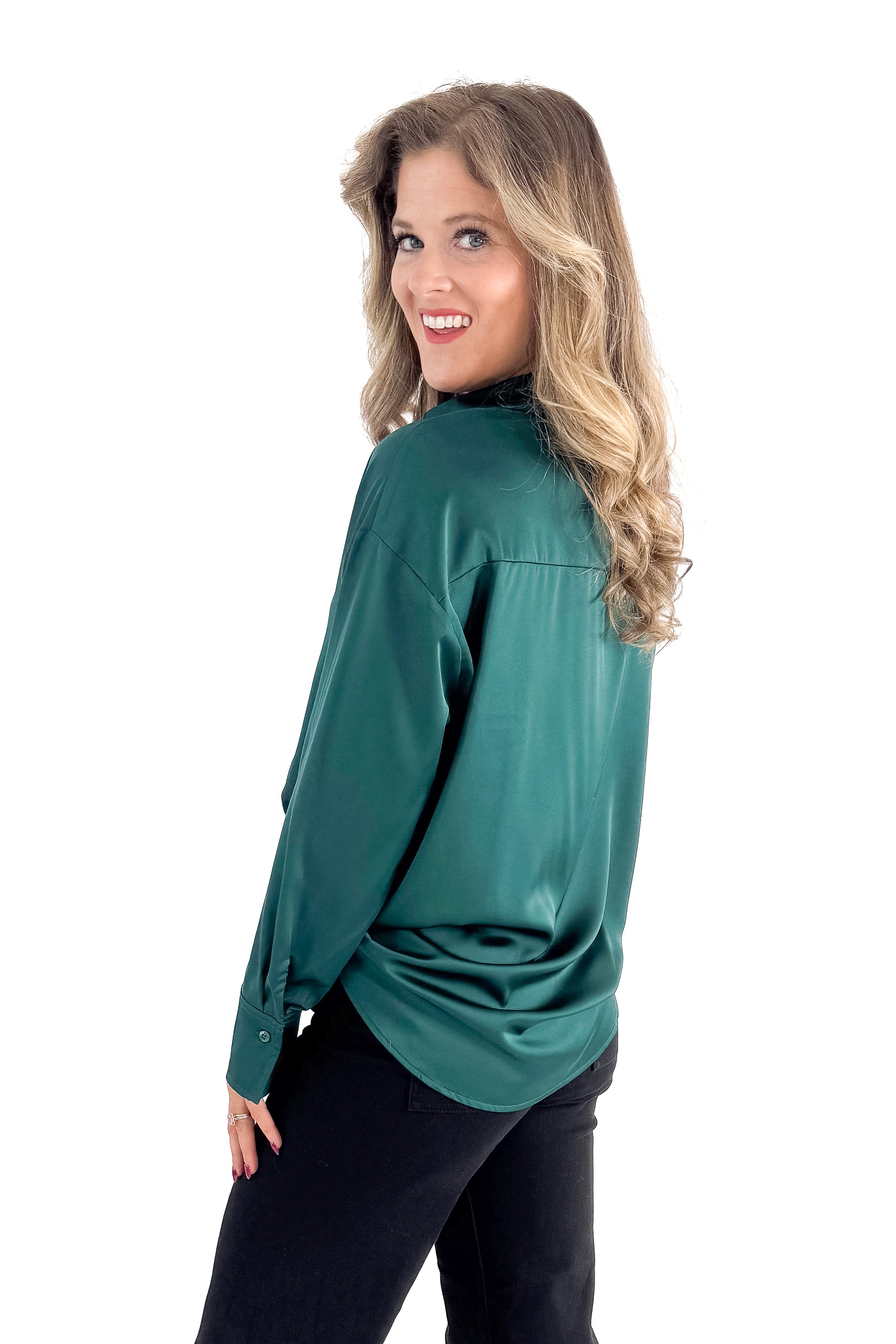 Side view of woman wearing Green Satin Collared V-neck Top with jeans against white studio background.