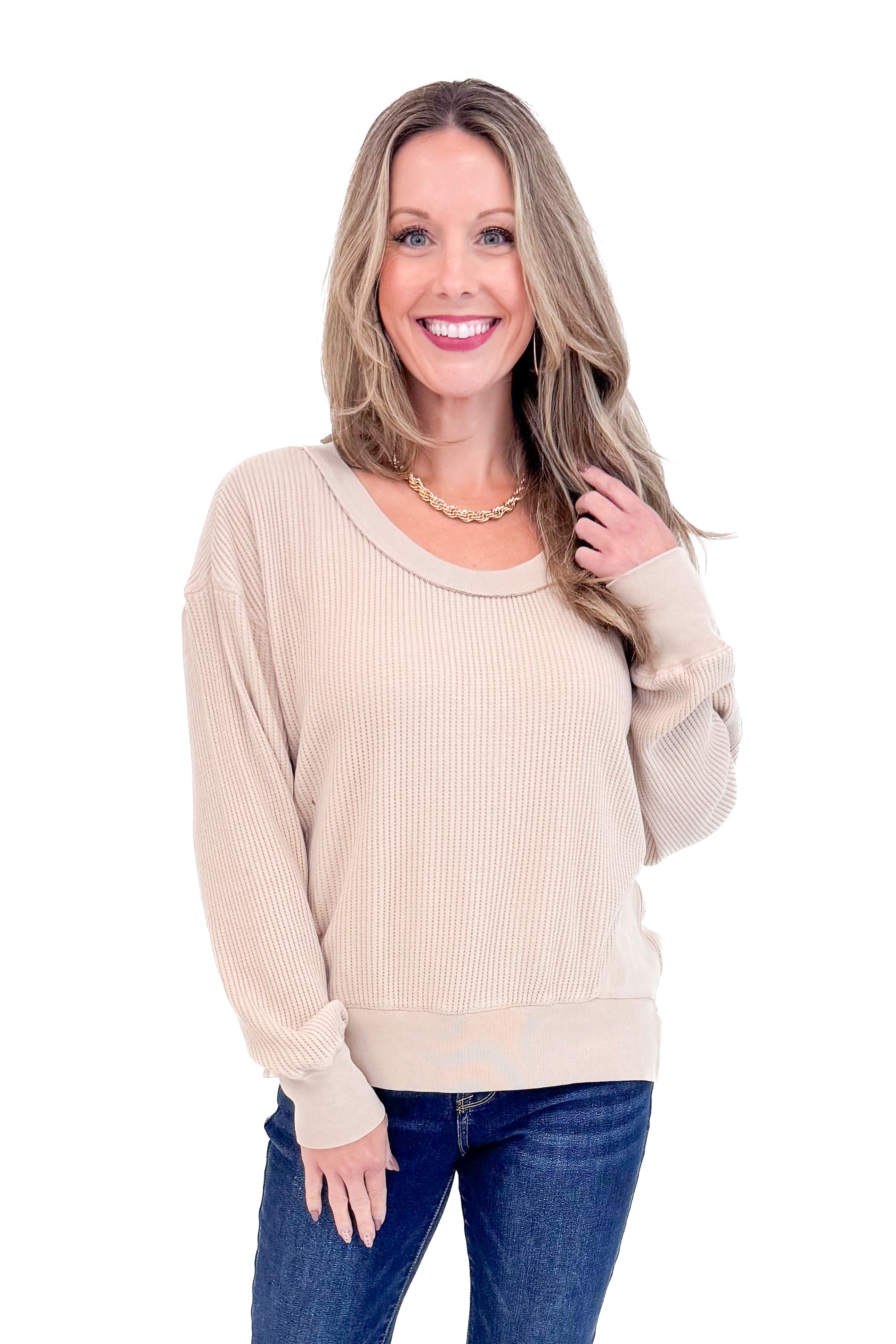 Front view of woman wearing Washed Taupe Round Neck Waffle Weave Top and blue jeans against a white background.