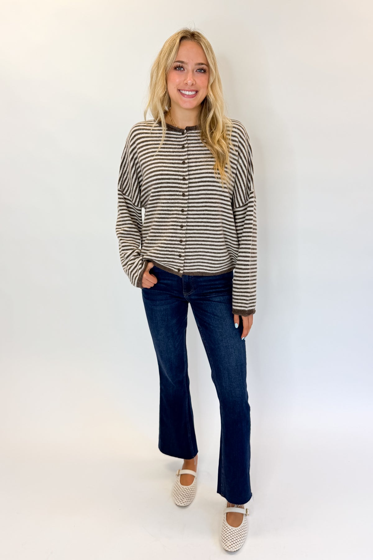 Front view of woman wearing Swagger Boutique’s Dark Brown & Cream Striped Button Up Cardigan with jeans against white studio background.