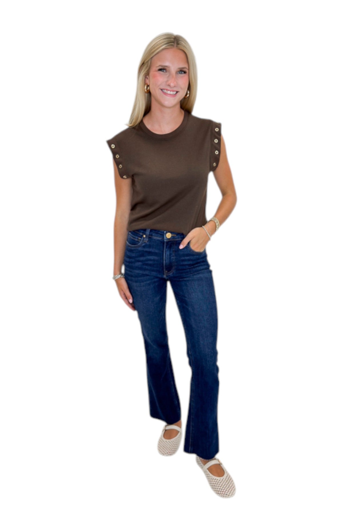 Front view of woman wearing Swagger Boutique’s Dark Chocolate Camino Grommet Top by Z Supply with jeans against white studio background.