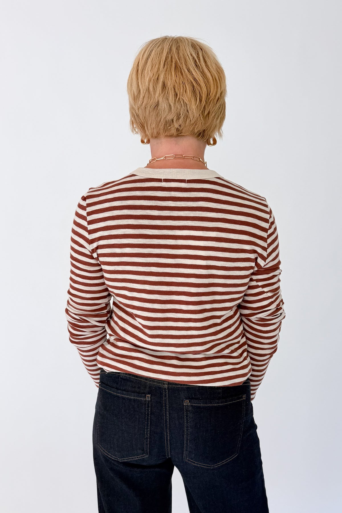Back view of woman wearing Swagger Boutique’s Dark Rosewood Junie Long Sleeve Stripe Slub Tee by Z Supply with jeans against white studio background.