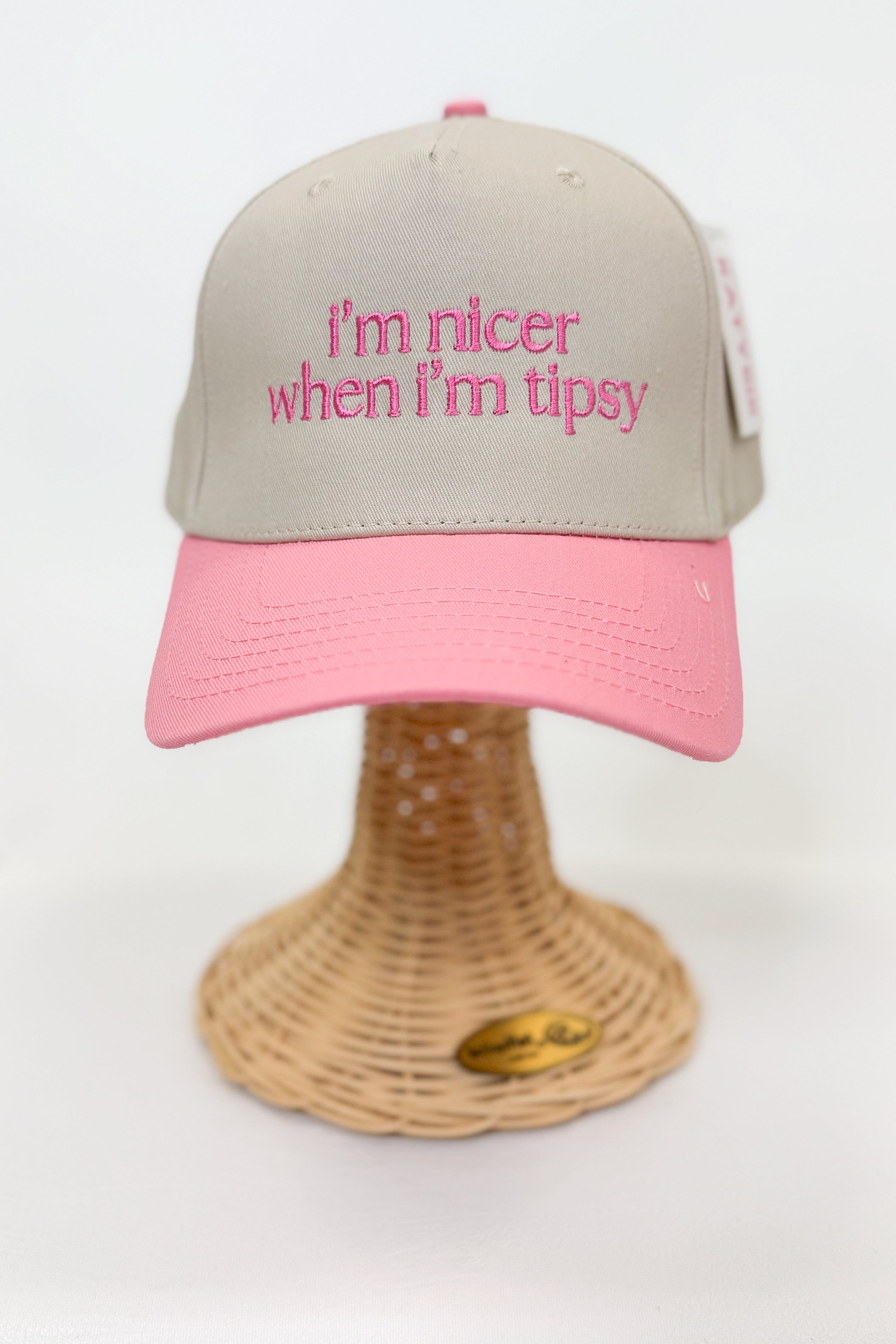Beige and pink cap with text on a white background