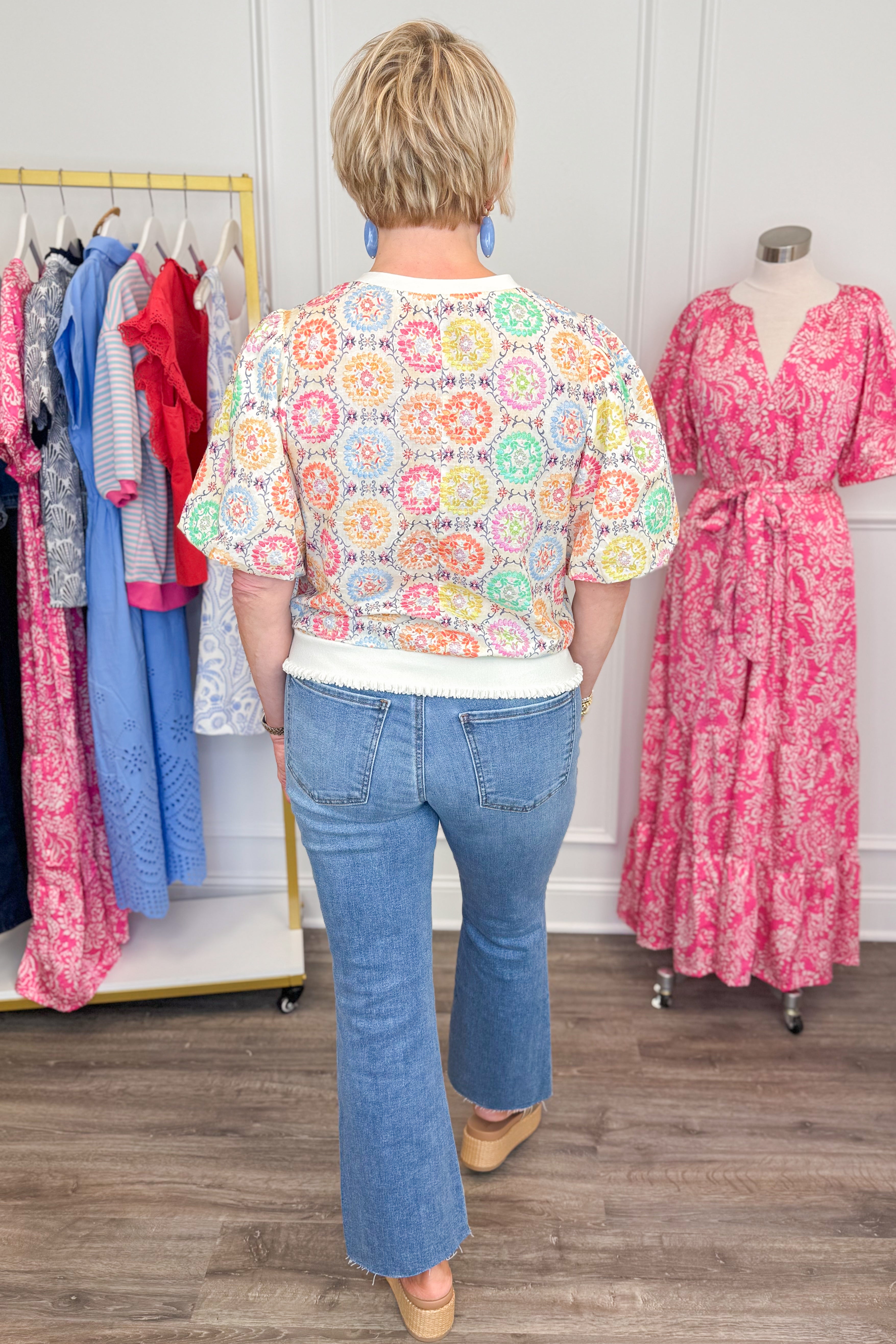 Back view of woman wearing Multi Circle & Floral Print Top with jeans and sandals.