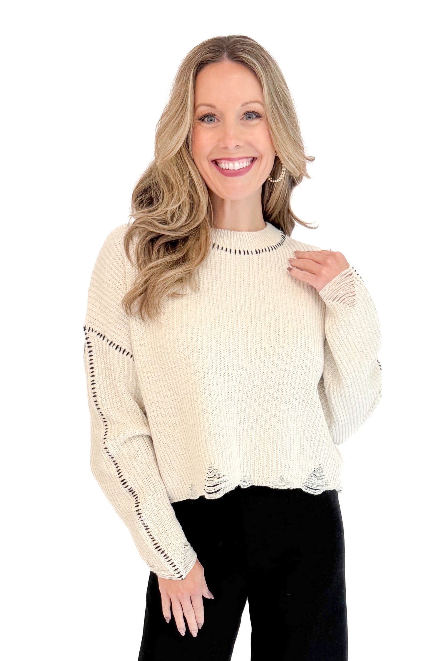 Front view of woman wearing stitch detail oatmeal sweater.