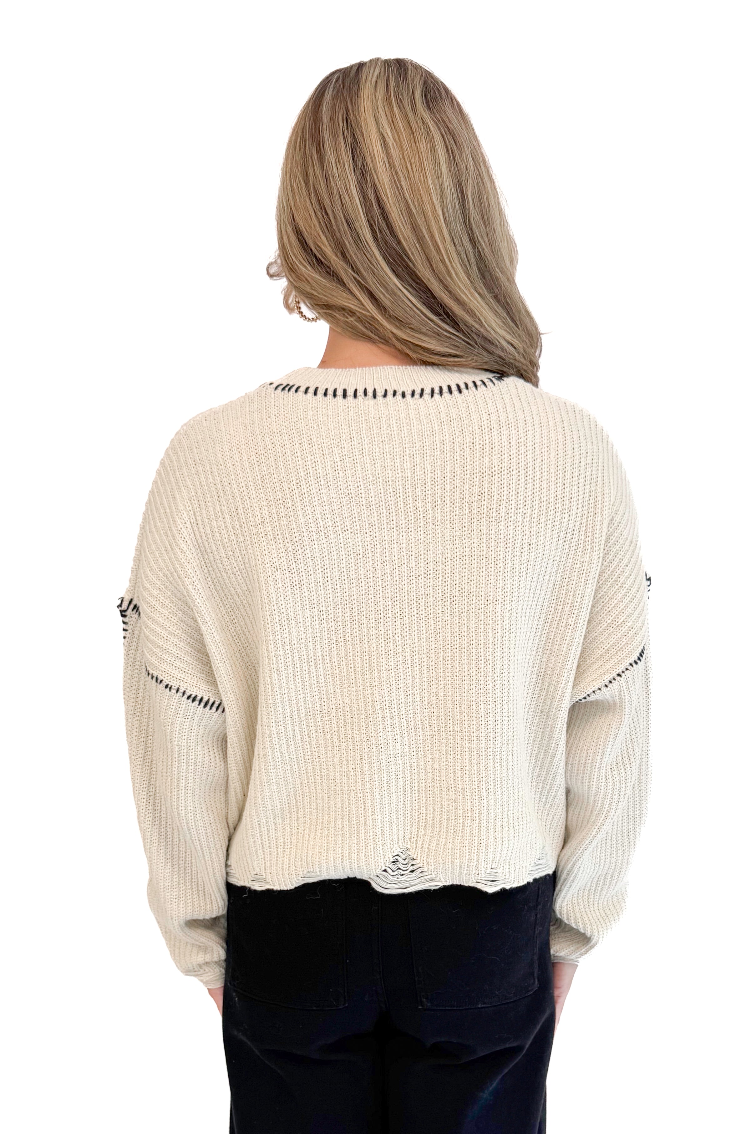 Back view of woman wearing stitch detail oatmeal sweater.