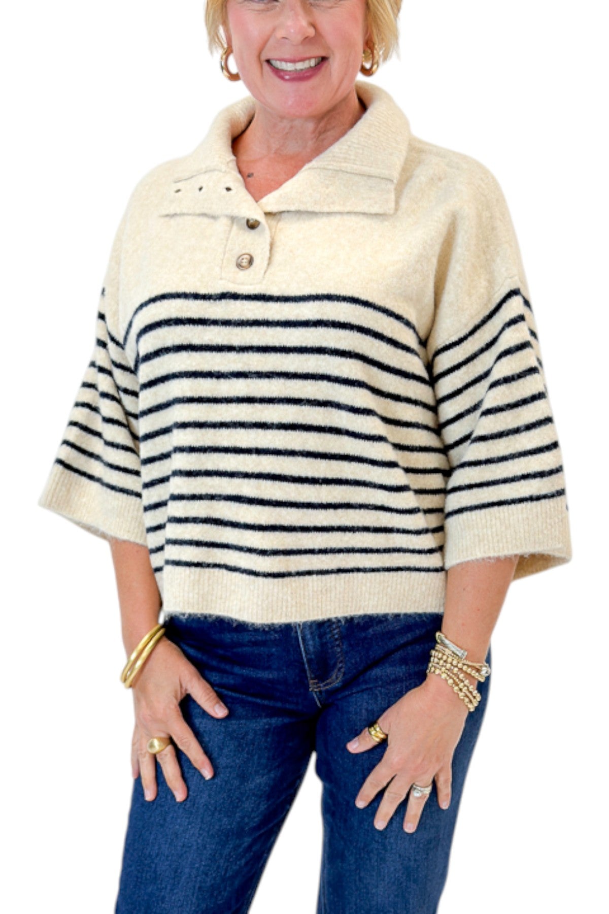 Front detail view of woman wearing Swagger Boutiqueās Ecru & Navy Striped 3/4 Sleeve Sweater by Entro with jeans against white studio background.