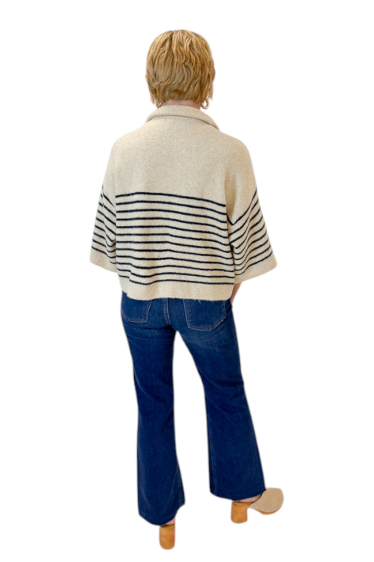 Back view of woman wearing Swagger Boutiqueās Ecru & Navy Striped 3/4 Sleeve Sweater by Entro with jeans against white studio background.