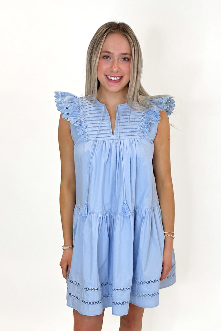 Front view of woman wearing Light Blue Eyelet Detail Dress with sandals against white studio background.