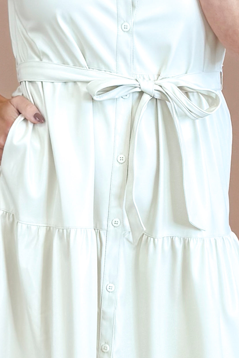 White dress with a belt on a plain background