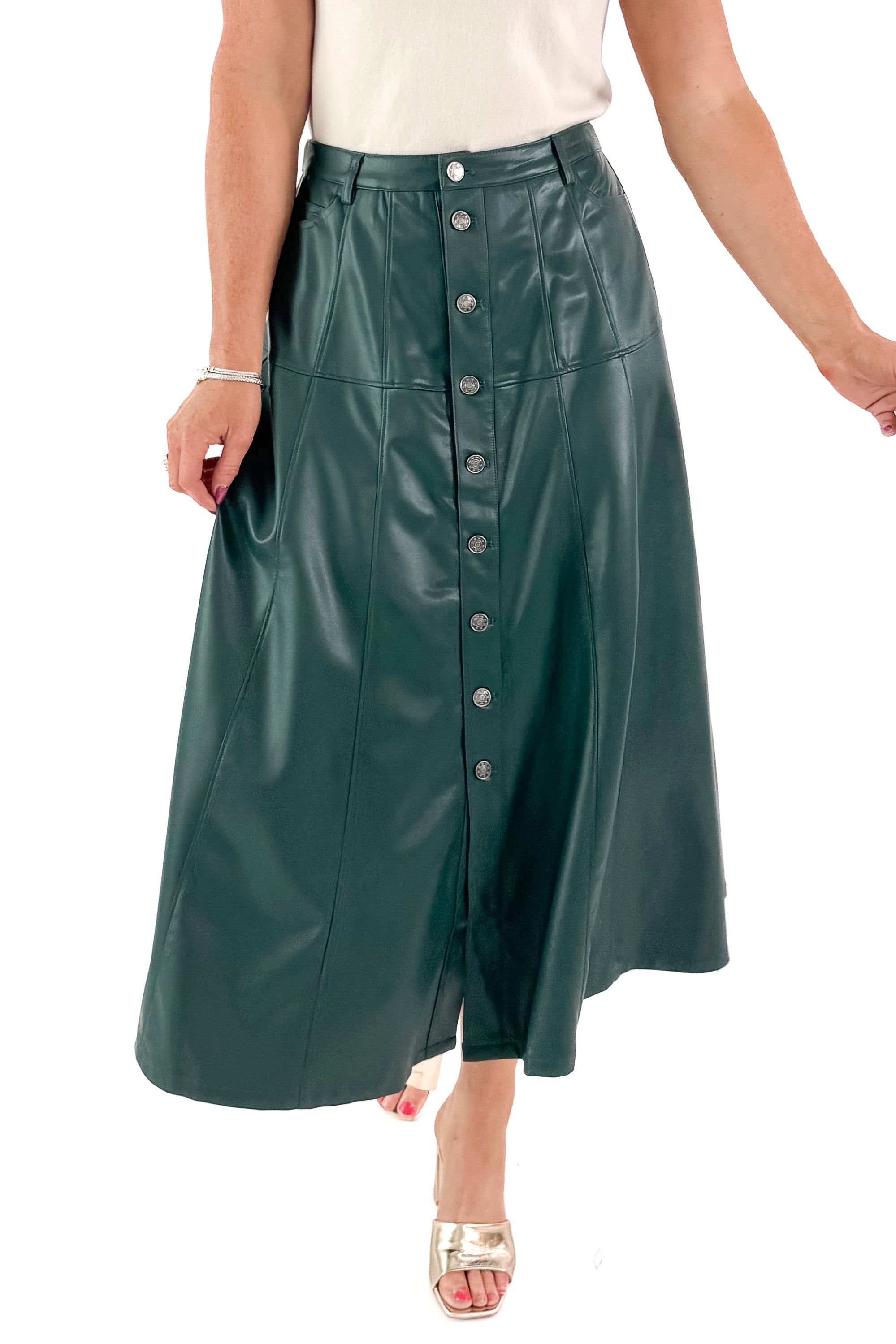 Front view of woman wearing Hunter Green Faux Leather Midi Skirt with top against white studio background.