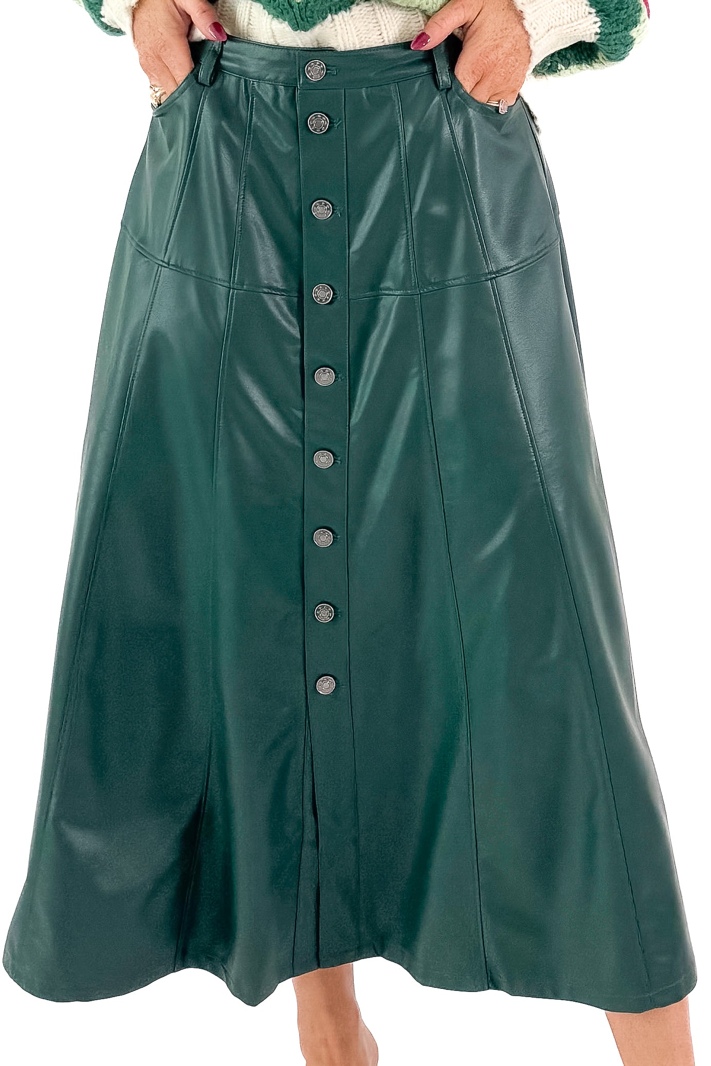 Front detailed view of woman wearing Hunter Green Faux Leather Midi Skirt with top against white studio background.