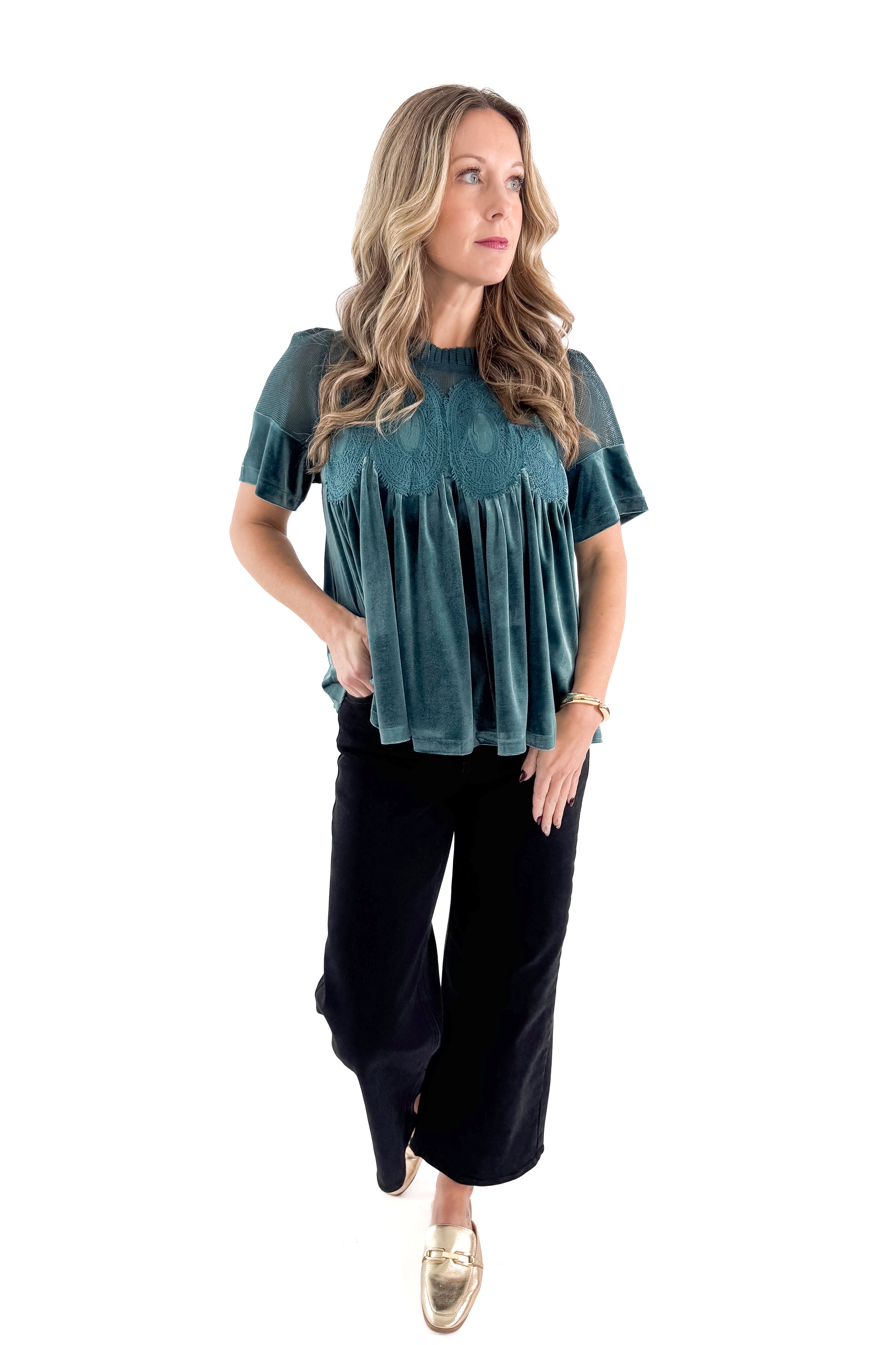 Front view of woman wearing Teal Velvet With Lace Applique Top with jeans against white studio background.