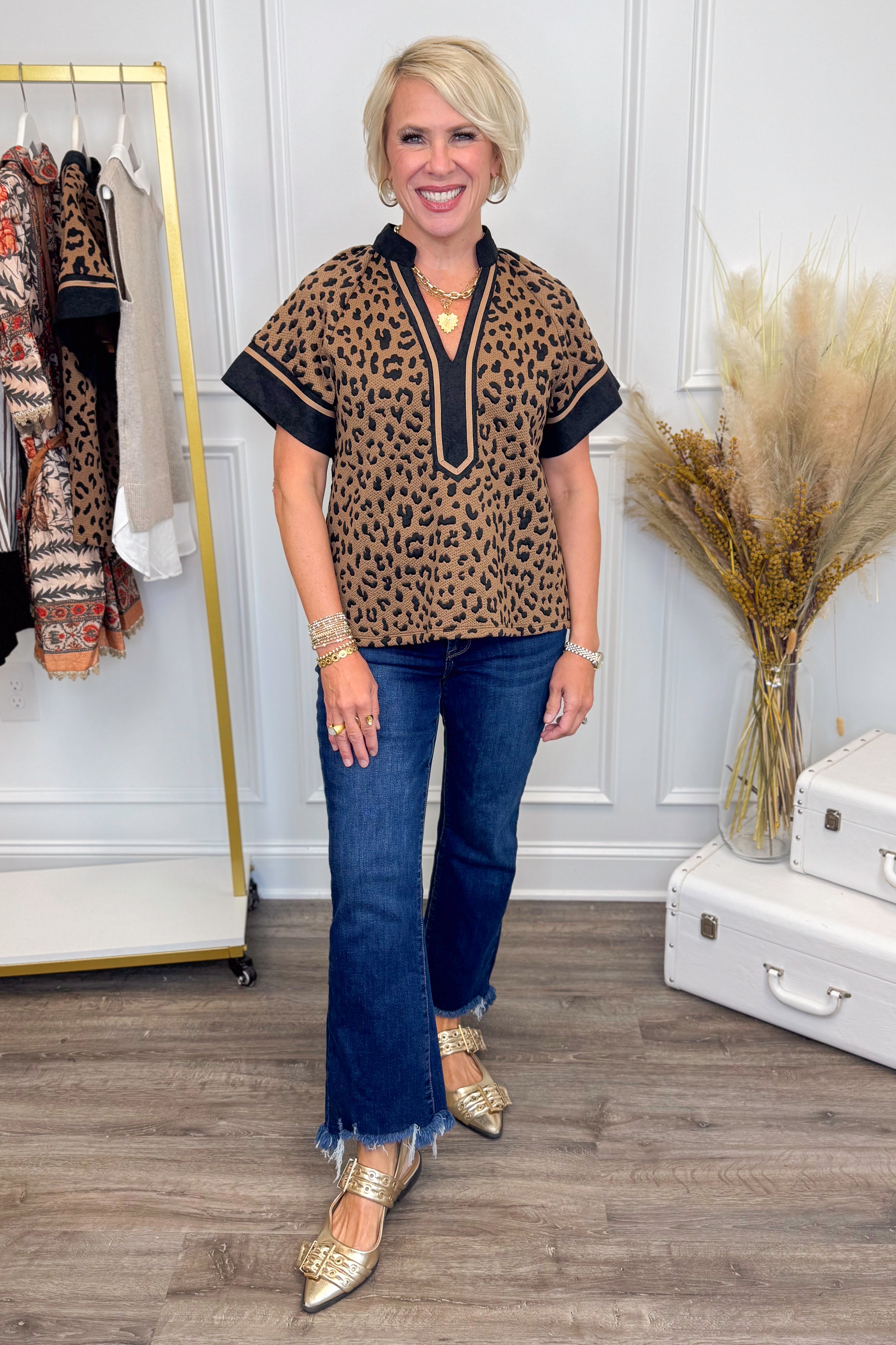 Woman wearing Looking For You Brown Leopard Textured Top by THML - front view showing leopard print pattern and textured fabric.
