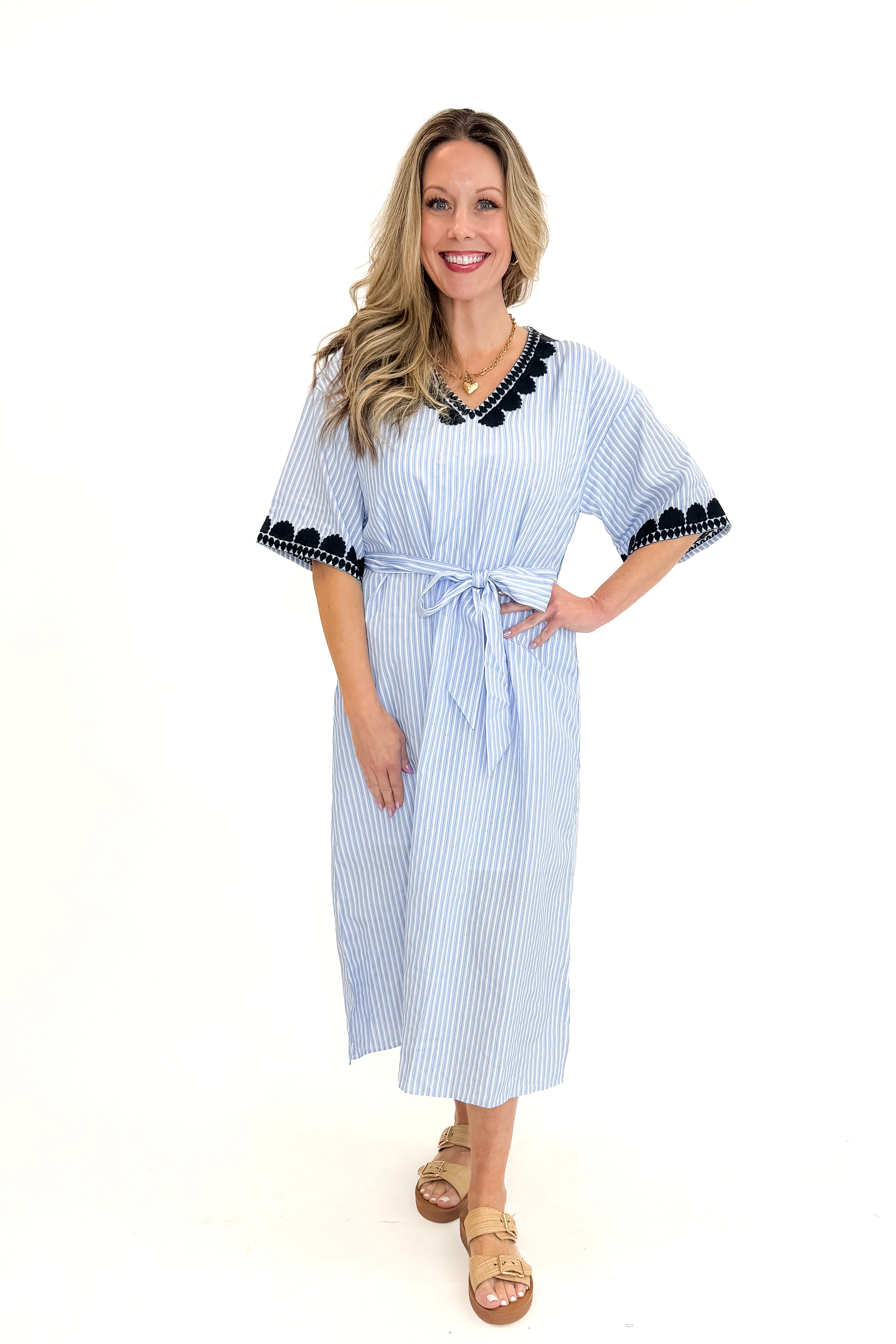 Front view of woman wearing Blue Striped Embroidery Accent Midi Dress with sandals against white studio background.