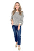 Front view of woman wearing Cream and Charcoal Striped Sweater with jeans against white studio background.