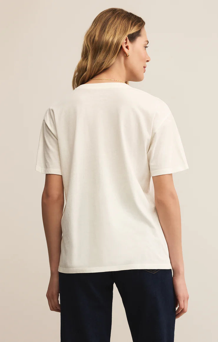 Stock photo back view of woman wearing Sea Salt Falalala Boyfriend Tee by Z Supply against studio background.