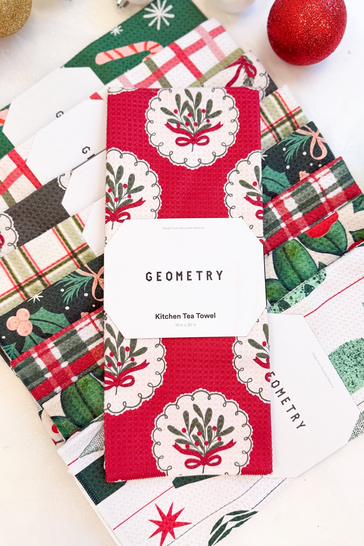 Geometry Merry Mistletoe Microfiber Tea Towel against holiday background.