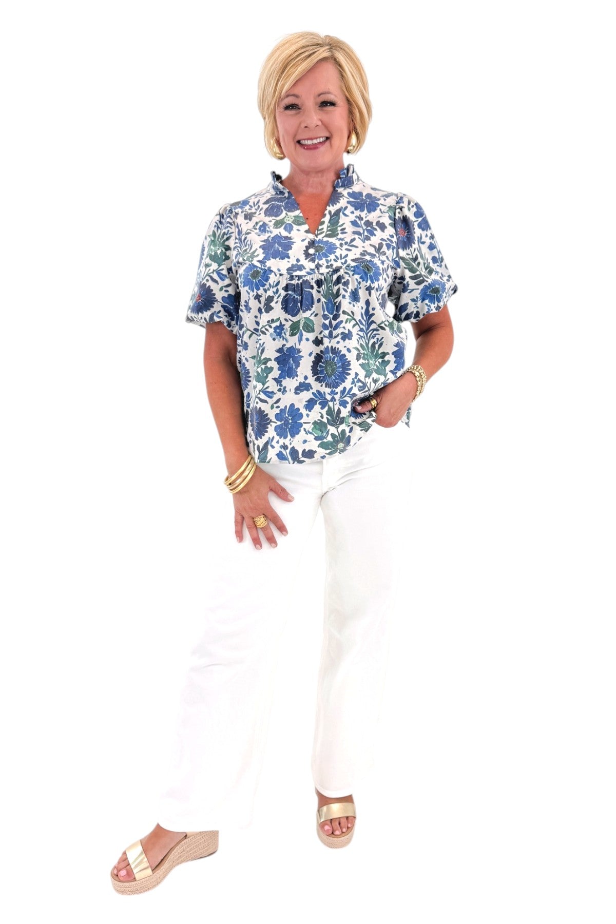 Front view of woman wearing Swagger Boutiqueβs Green & Blue Floral V-Neck Top with sandals against white studio background.