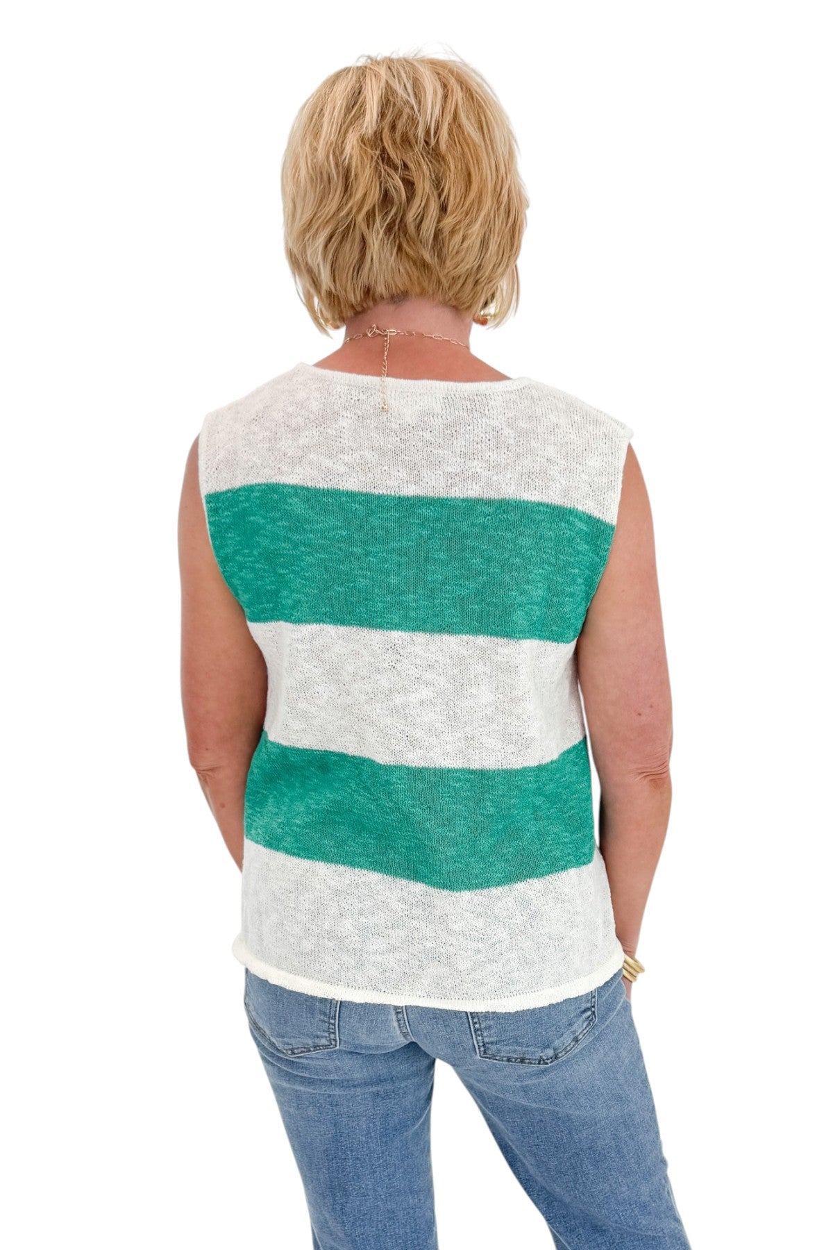 Back view of woman wearing Swagger Boutiqueās Green & White Striped Sleeveless Sweater with jeans against white studio background.