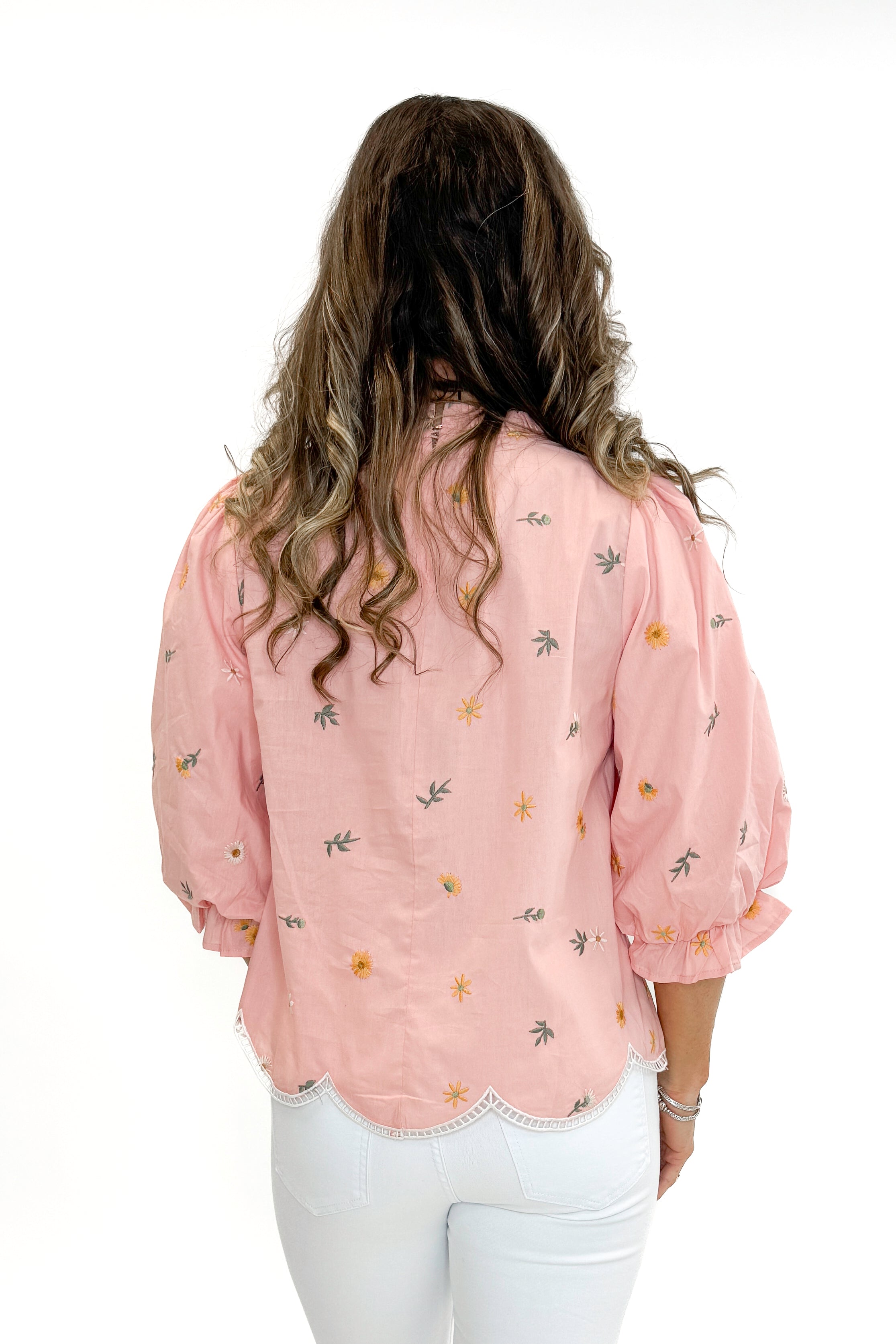 Back view of woman wearing Blush Embroidered Scallop Hem Top with jeans against white studio background.